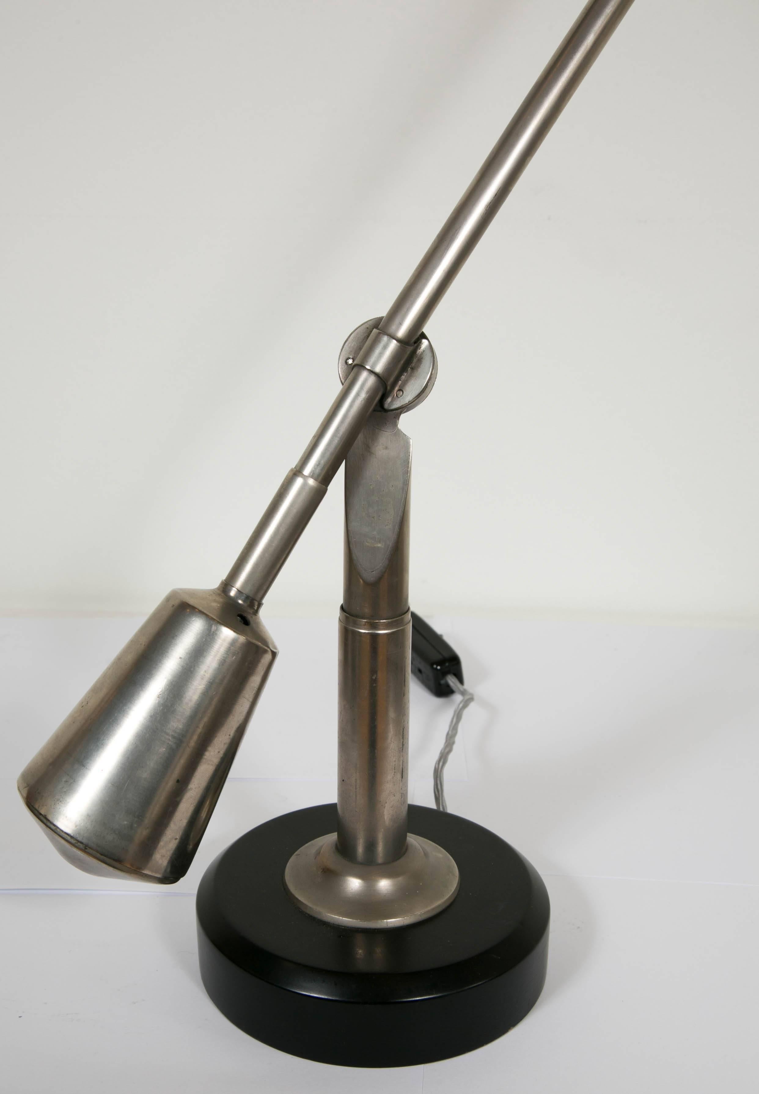 This iconic lamp is an original one and the most sought after lamp designed by Edouard-Wilfred Buquet (1886-?). It is an articulated lamp with two arms. It is balanced like a mobile with two adjustable counterweights. It is made of nickel-plated