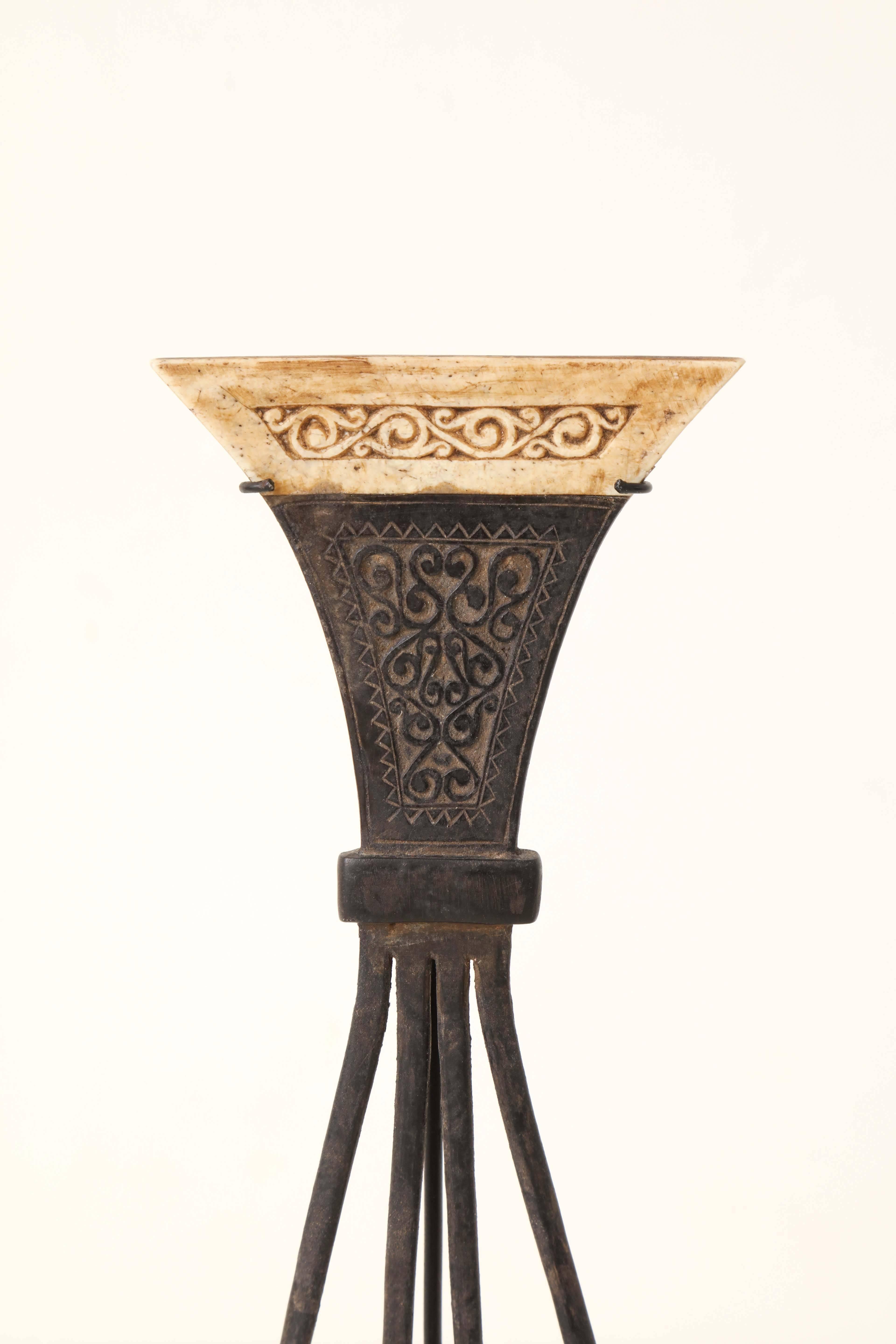 A late 19th-early 20th century Indonesian carved wood and bone Moluccas comb, mounted on a contemporary stand.