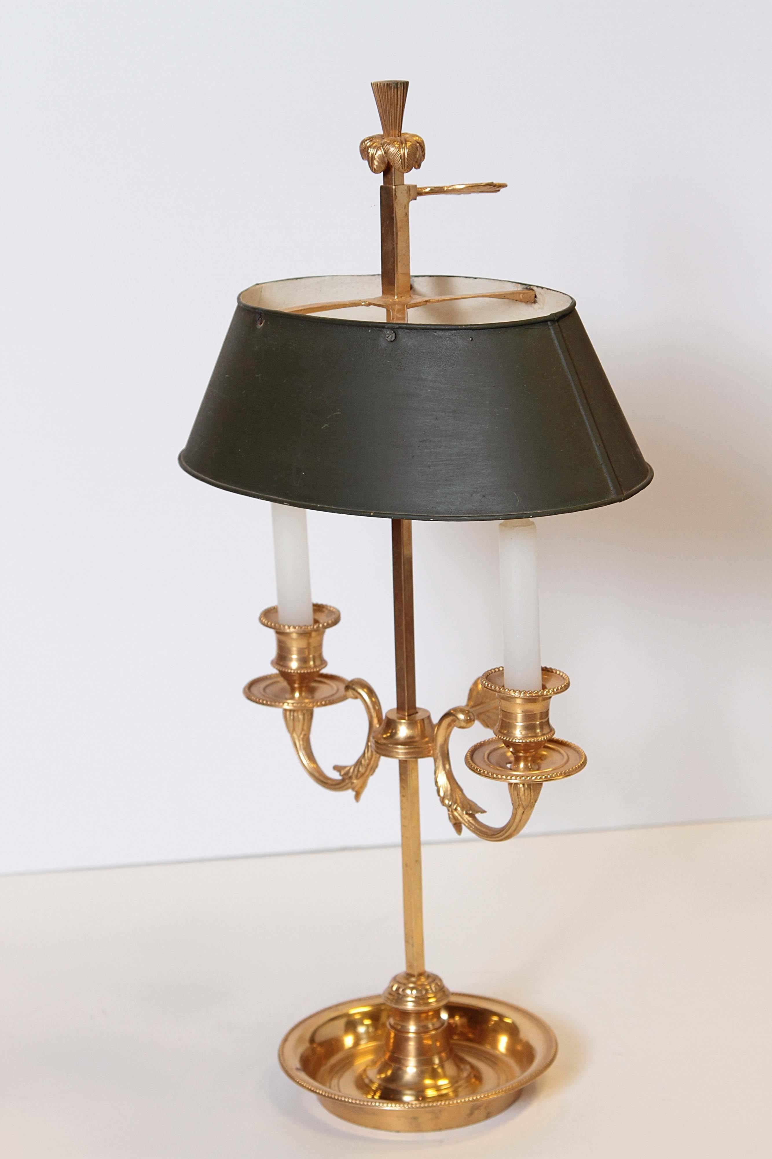 20th century Bouilotte lamp with two arms and oval shade. Lamp is not currently electrified. Holes are in place for re-wiring if desired. Shade is adjustable. Arms are adjustable.