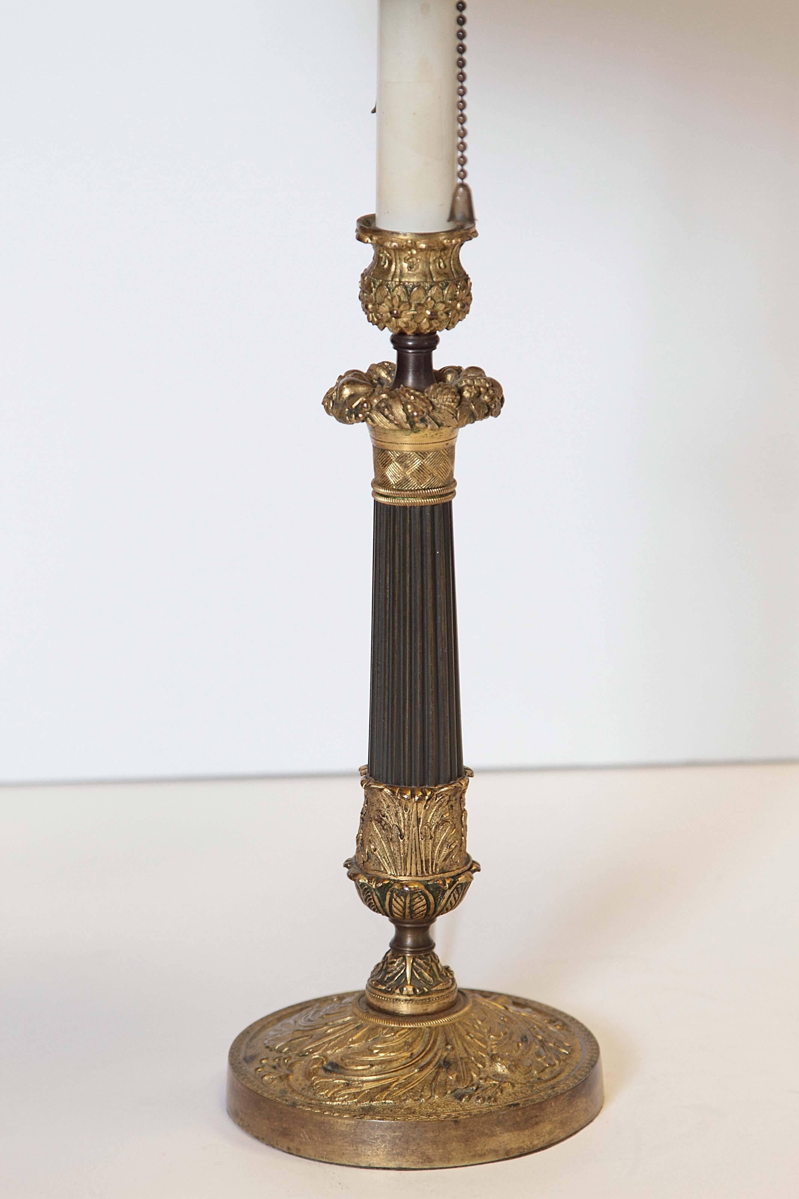 French Charles X column lamp. Patinated and non-patinated bronze. Painted tole shade.