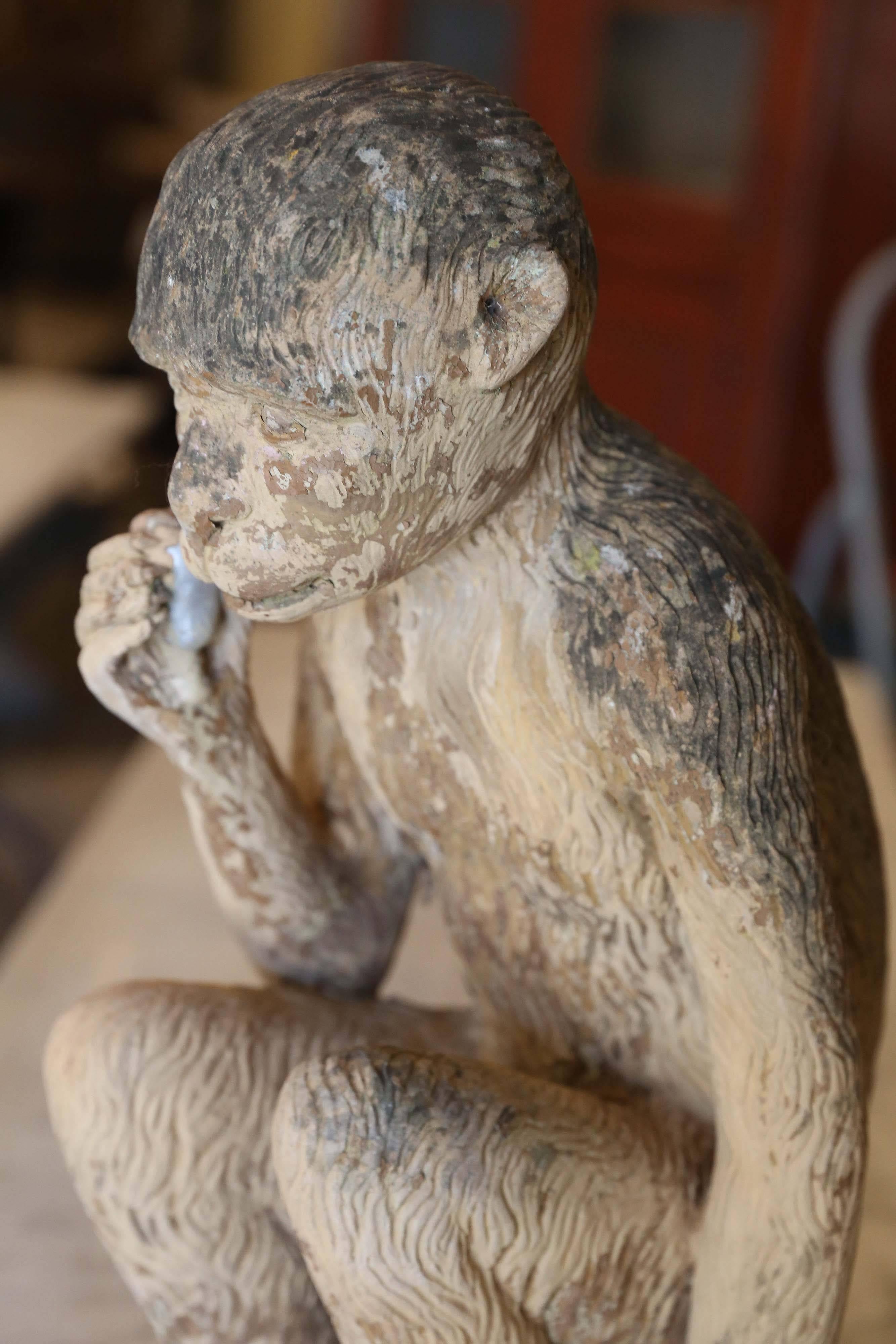 Terracotta monkey holding a glazed fig, the symbol of fertility, Majorca, circa 1950.
