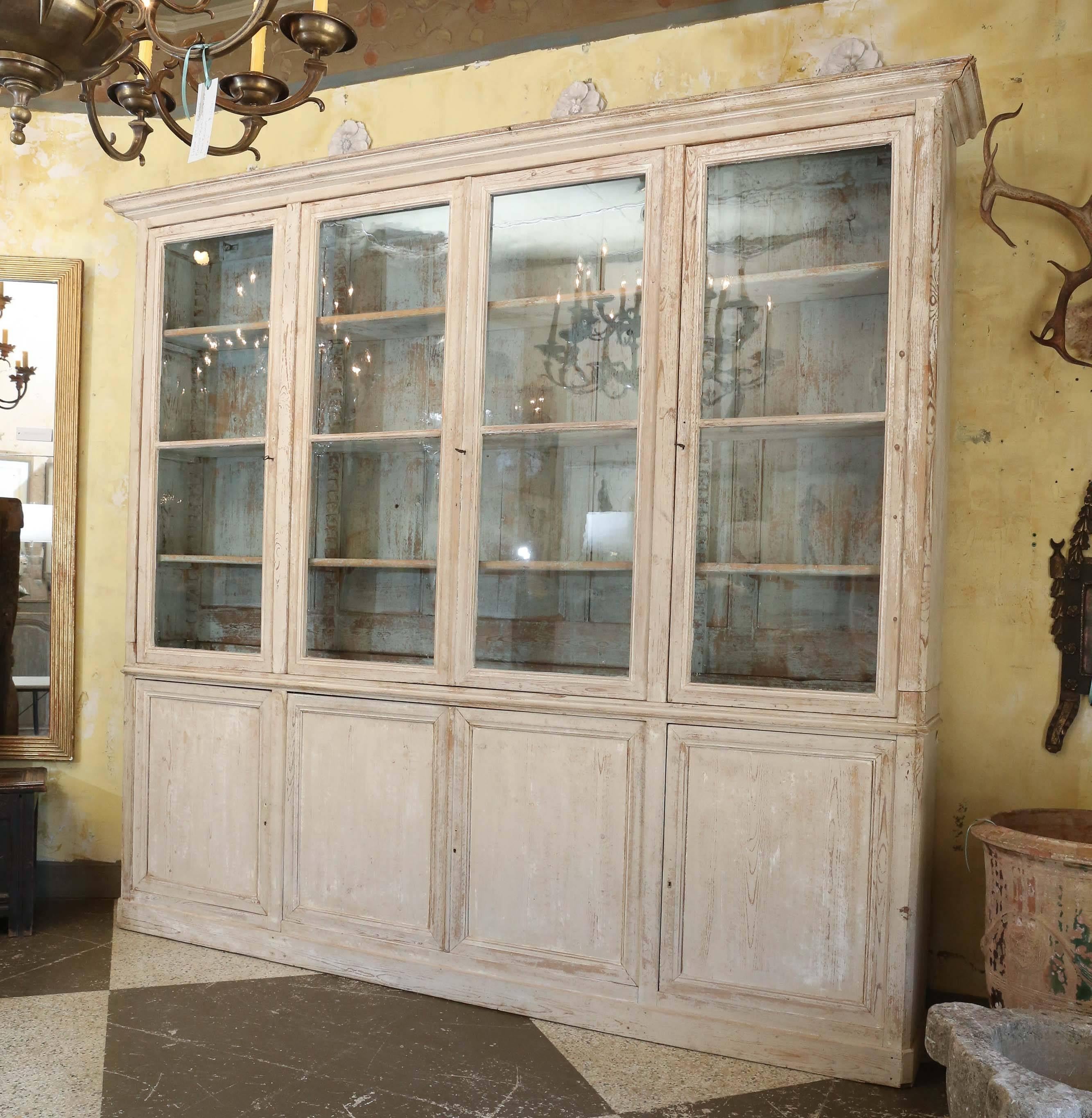 French painted bookcase with four glass doors and four wood doors on the base. Has original lock and key. Measures: 113.5