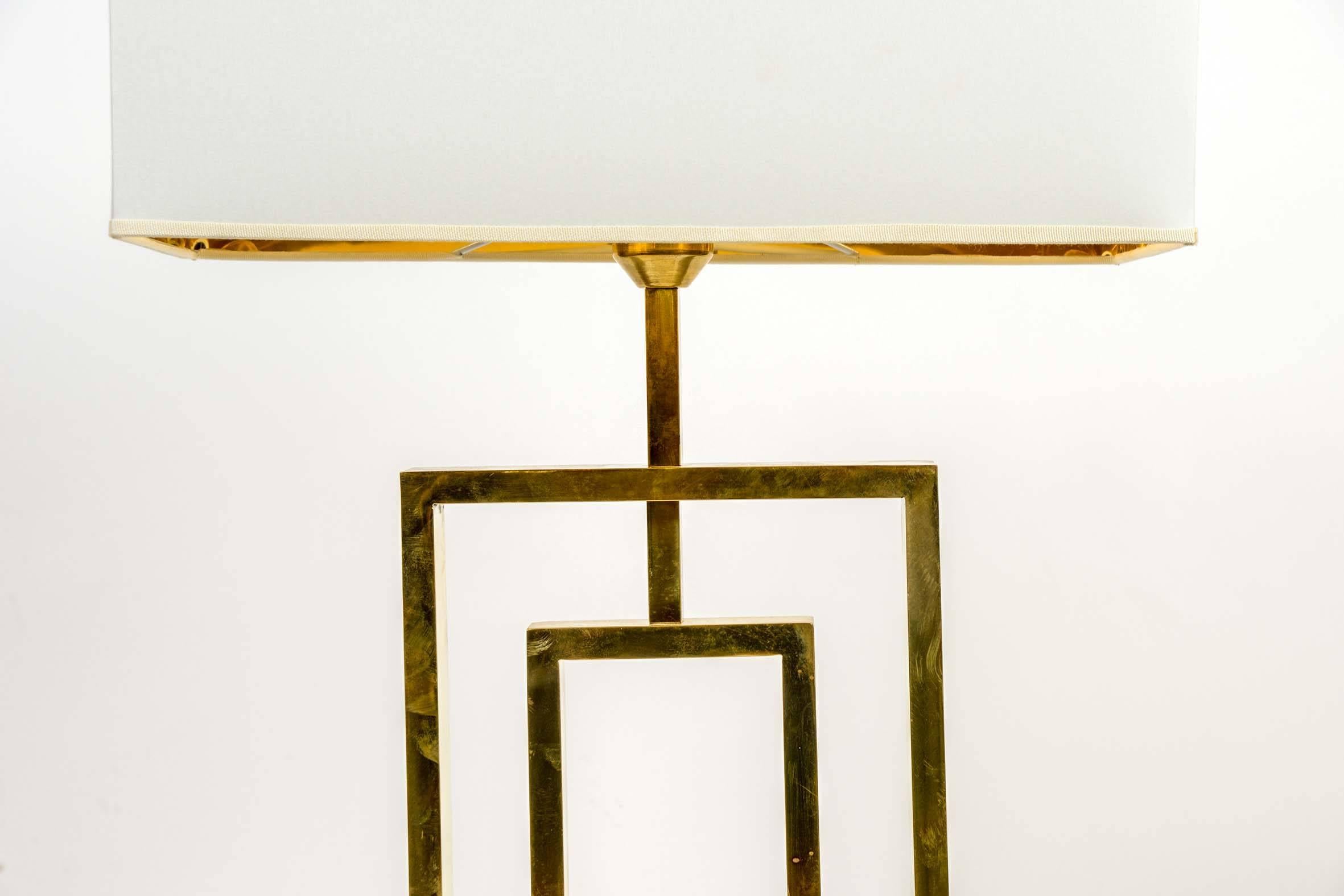 Simple and pure pair of table lamps made of brass rectangles structures.
