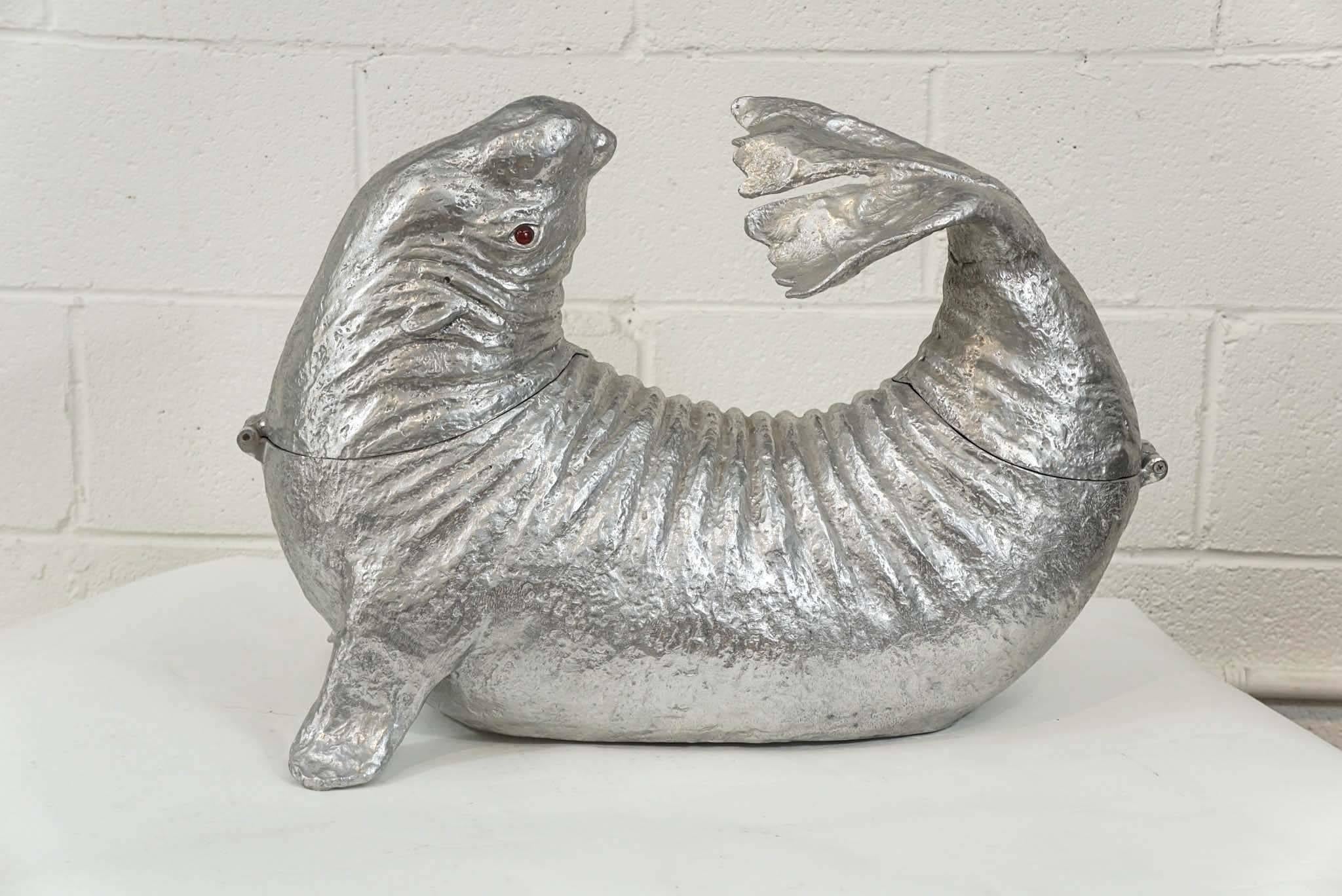 Here is an amazing Arthur Court sea lion ice bucket in cast aluminum.
The head and tail open and the vessel can be filled with ice and a bottle or two of champagne! Great for parties!