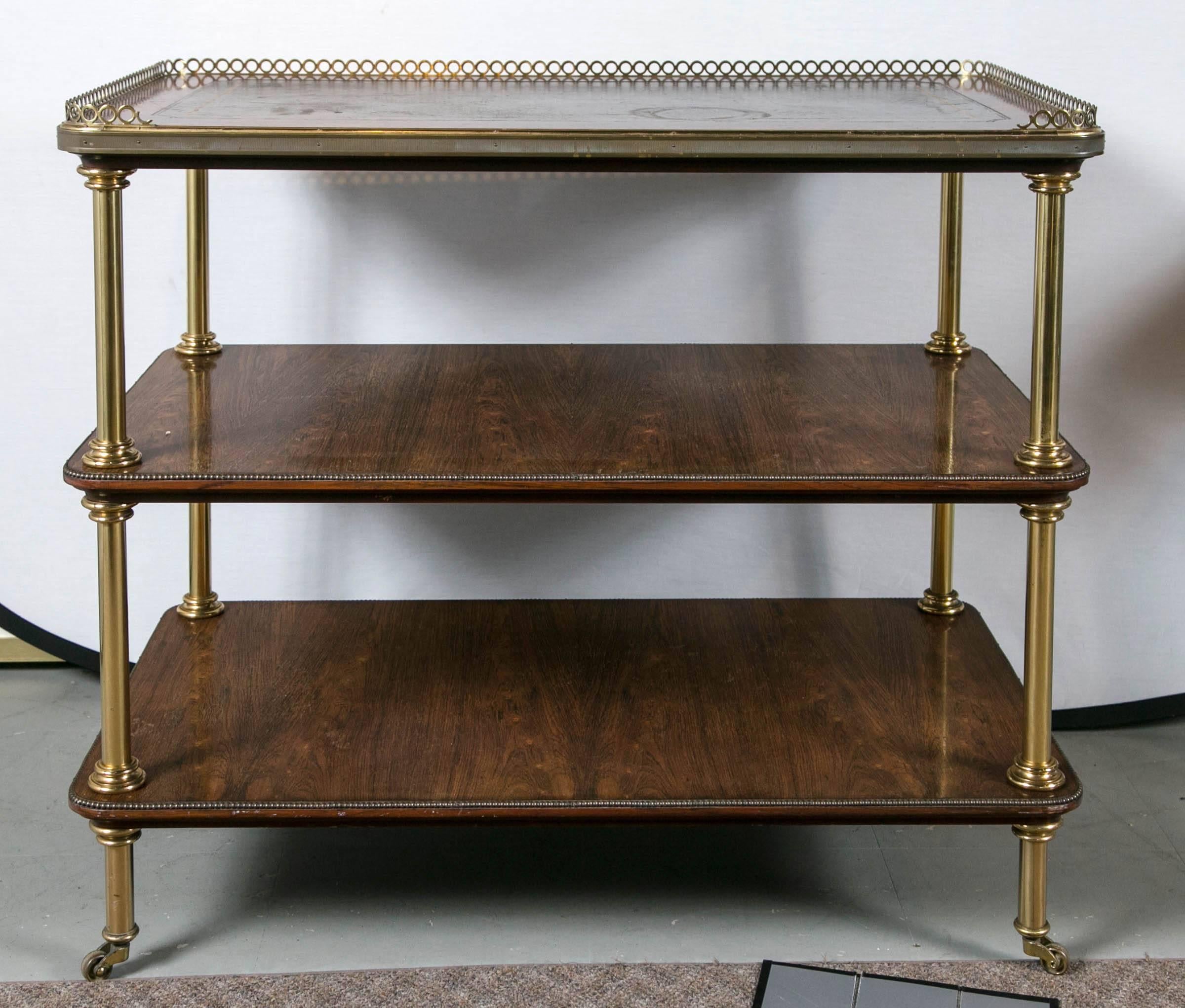 Baker rosewood three-shelf cart with brass accents and casters, circa 1960s.