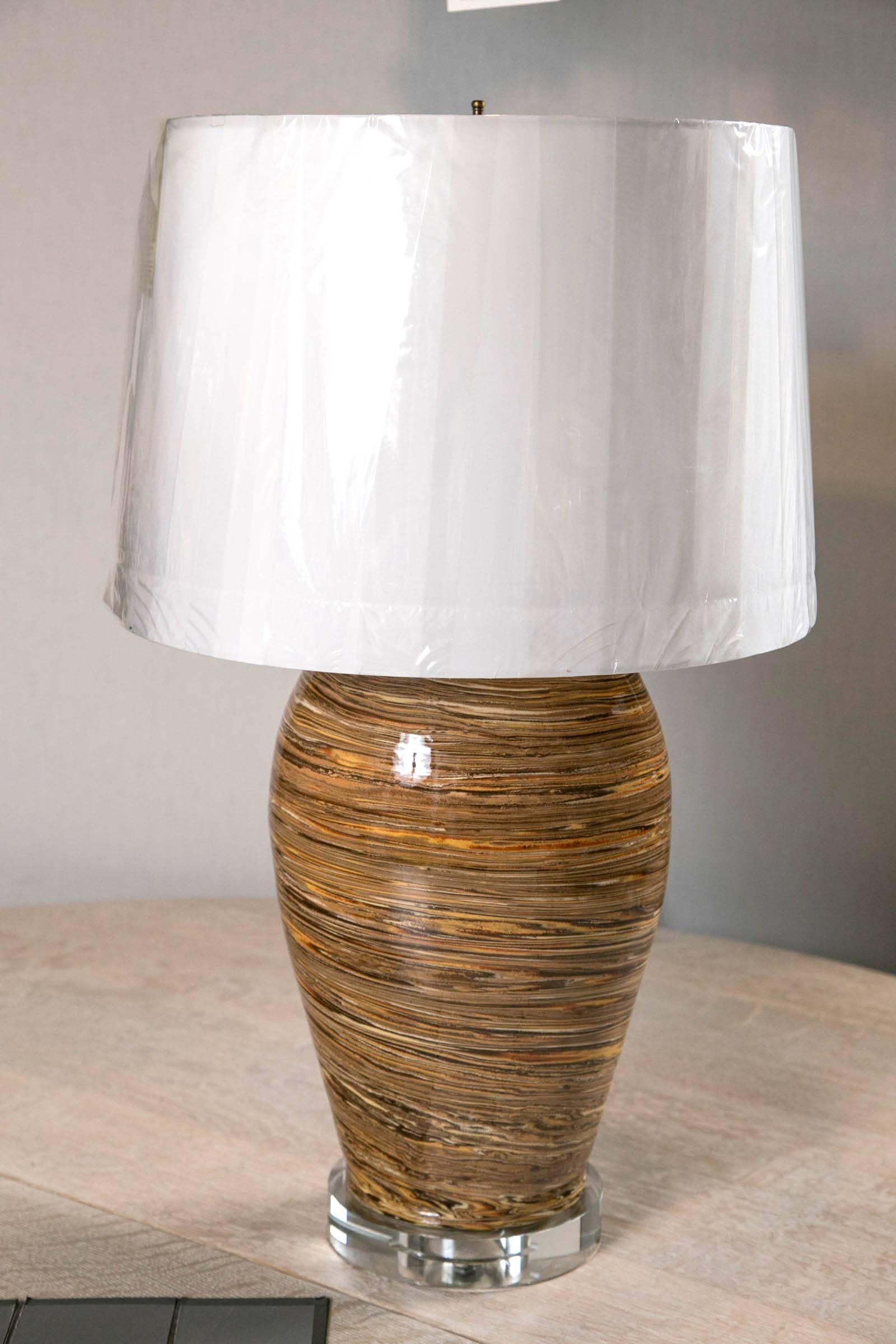 Made in Apt France this pair of hand thrown pottery lamps are just the right touch of handmade. Lucite bases make them very stylish indeed.These lamps are priced at $2950 each.