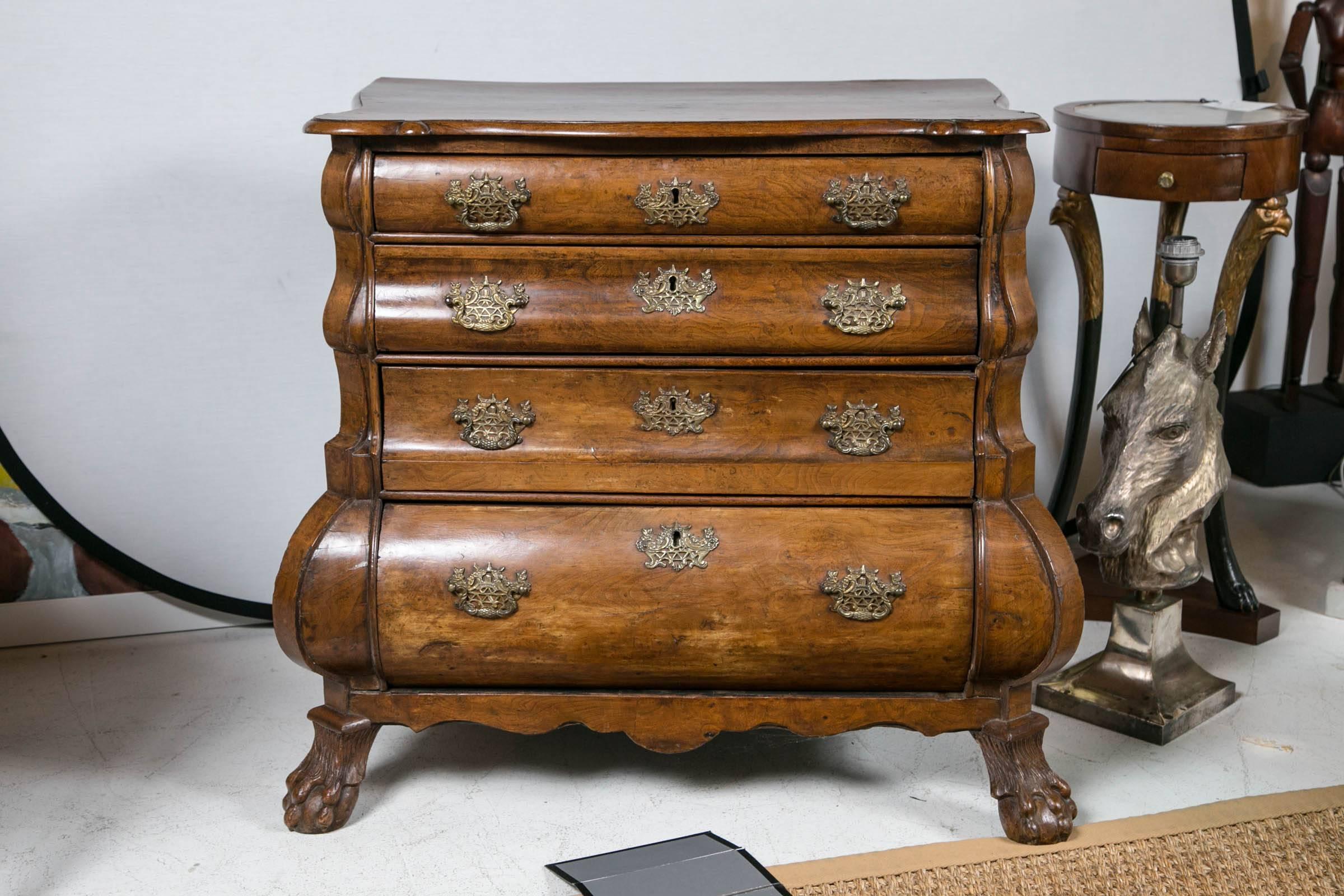 Beautiful 18th century walnut bombe chest on ball and claw feet. Great brasses.