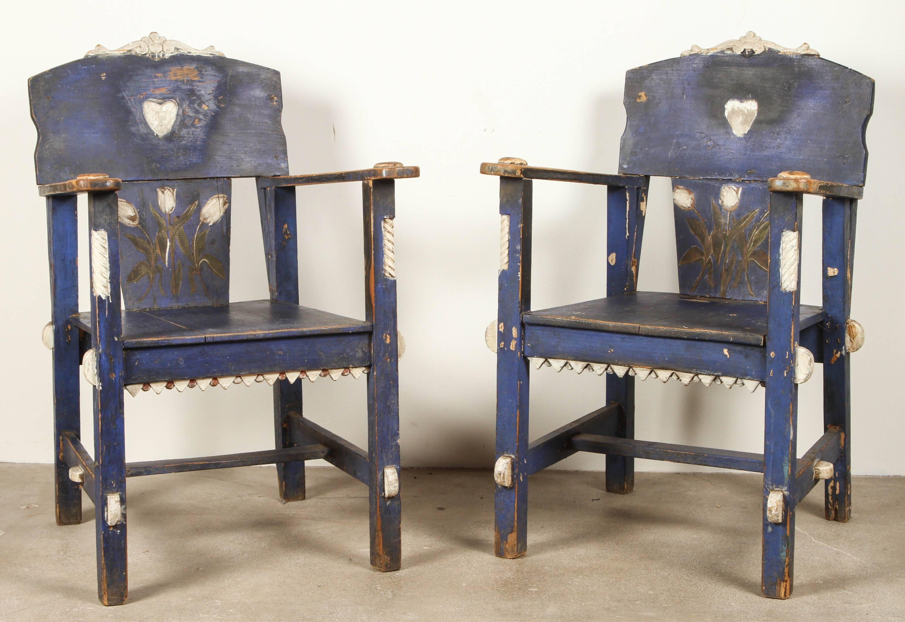 Folk style blue painted Mexican armchairs with tulip motif.