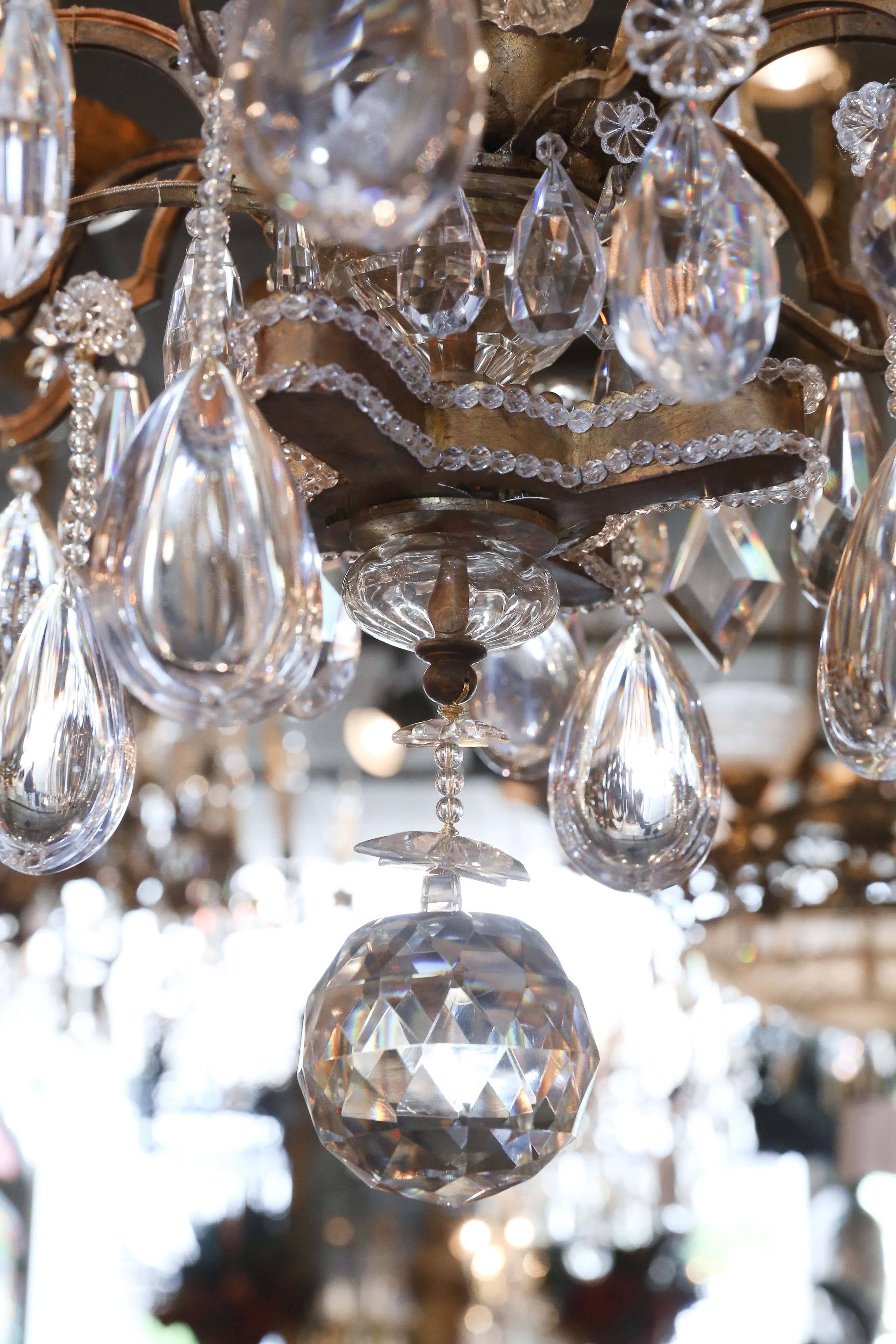 Exceptional large bronze and crystal Bagues chandelier having an
unusual spiral form that is made of crystal beads. It has an elegant
elongated shape and bronze doré bobeches. It has 8 outer arms, 6 lights in
The upper circle , 3 in the middle and 4
