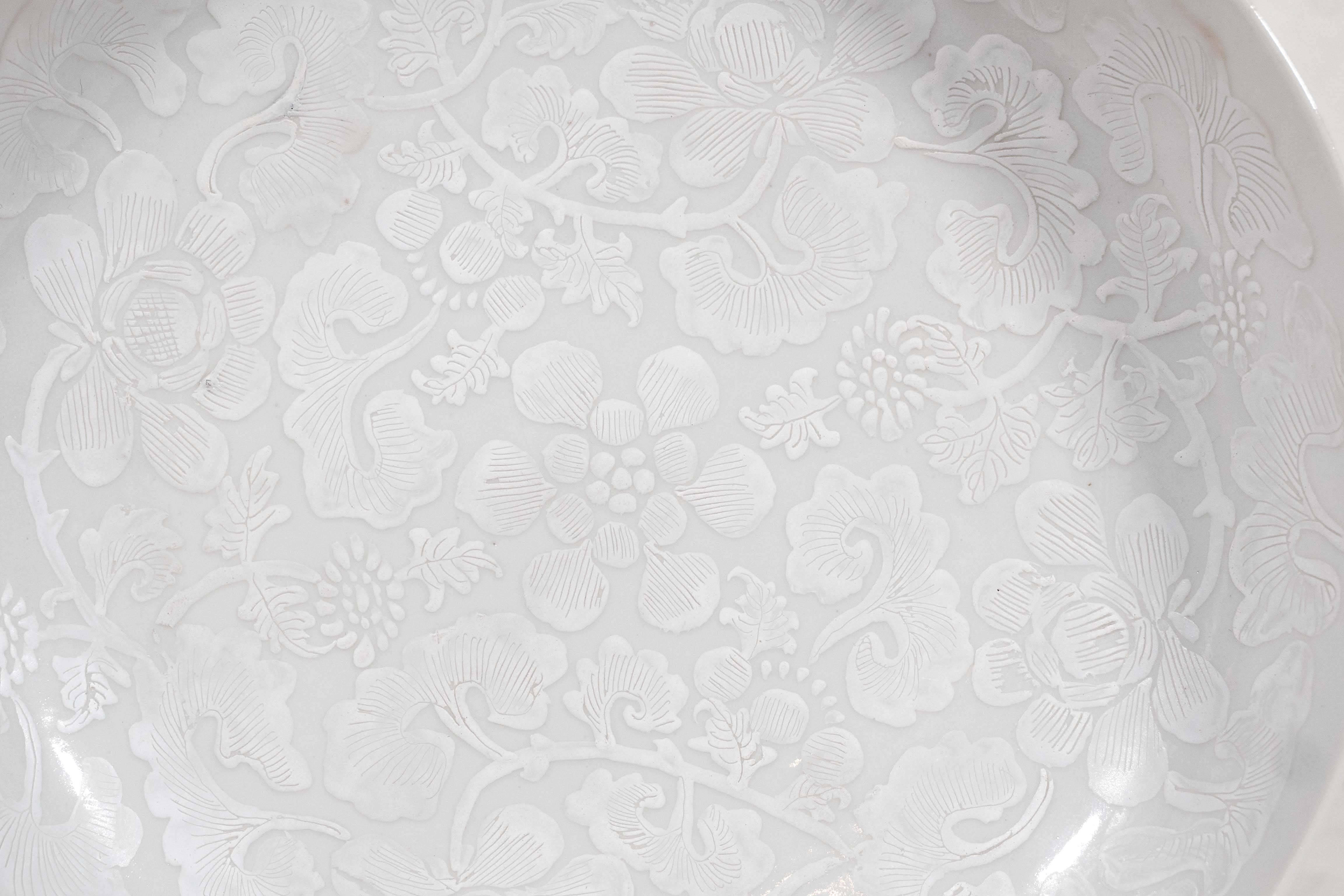 An exceptional Chinese porcelain dish painted with white on white (Bianco Sopra Bianco). The white enamels on the white porcelain creates the effect of lace laid down on the porcelain. Made during the Qianlong period, circa 1750. The design shows