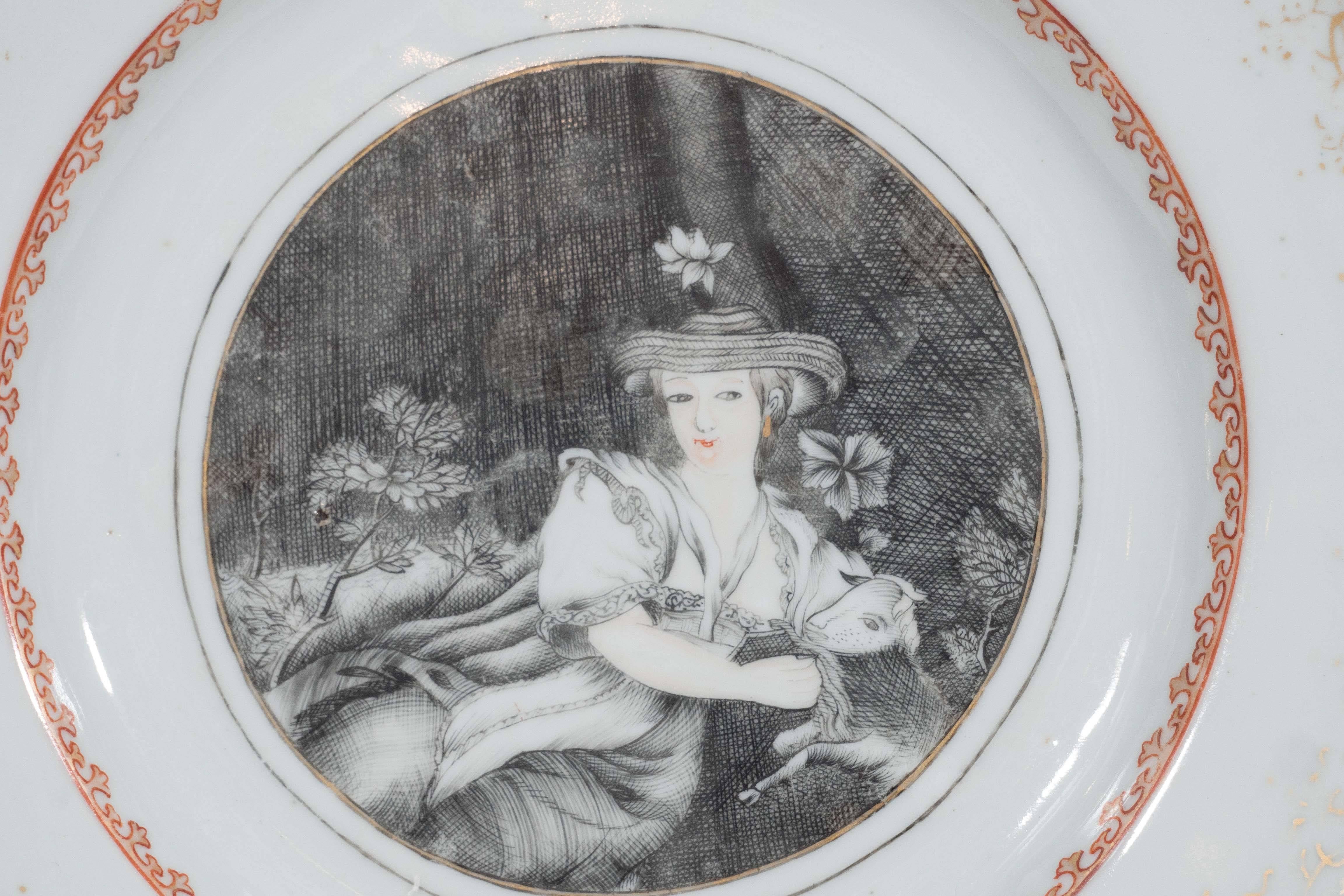 We are pleased to offer this Chinese export dish with a European scene showing a shepherdess. We see her wearing a straw hat with a flower, and resting seated beside a tree trunk, and holding a baby sheep. She is painted in grisaille, and gilt, her