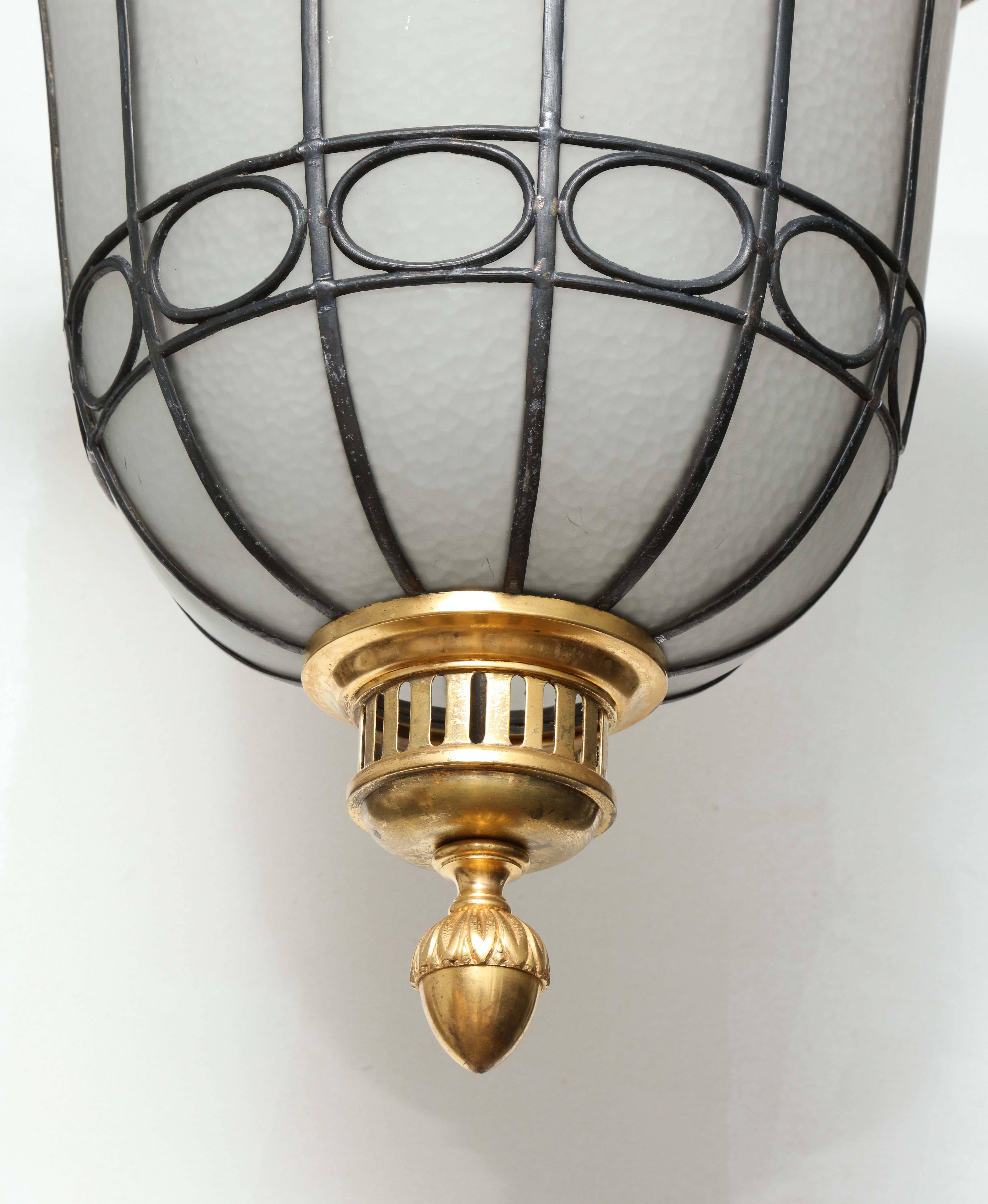 A remarkable set of four early 20th century Beaux-Arts hanging lanterns attributed to Edward F. Caldwell & Company of New York City, one of the premier designers and manufacturers of electric light fixtures and decorative metalwork for private and