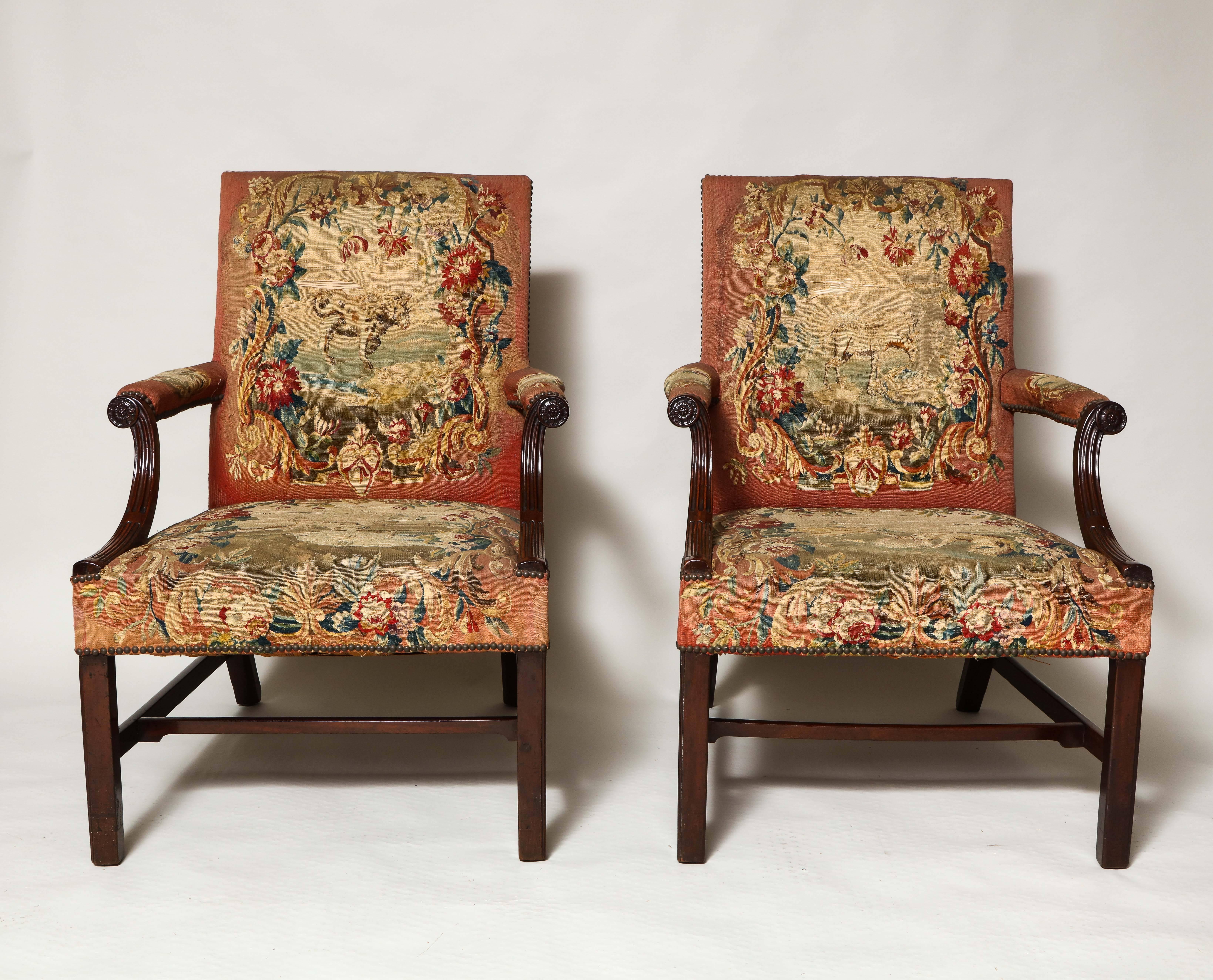 Stunning pair of George III library armchairs upholstered in period needlework depicting several Aesop's Fables, the square backs over padded arms with stop fluted details and carved rosette ends over square Marlborough legs joined by stretchers,