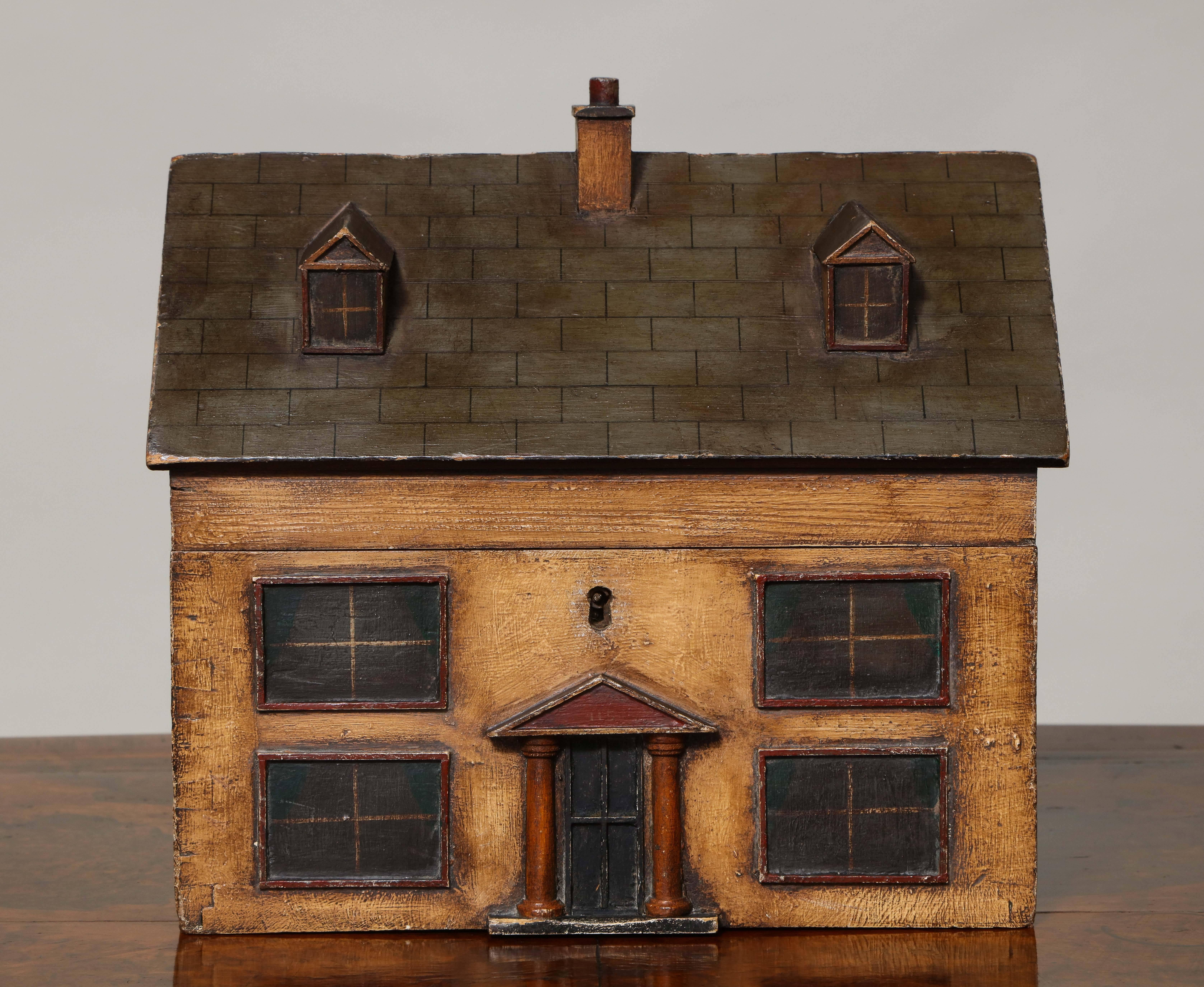 Rare 19th century English box/caddy in the form of a Georgian center hall house, the faux slate roof with center chimney and two dormer windows, the facade with columned entrance way flanked by two pairs of windows, the sides with vines and,