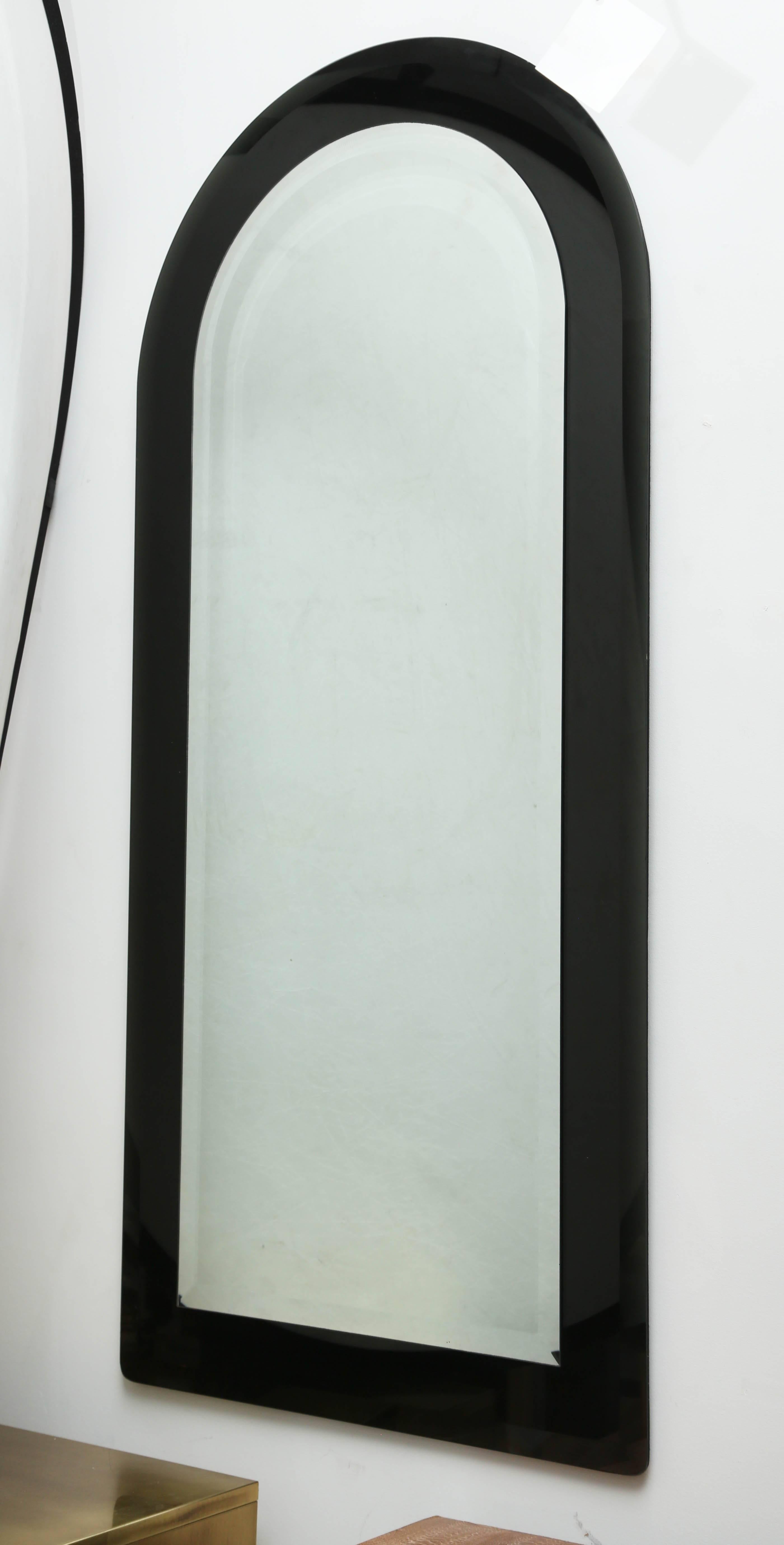 Black glass floating mirror with beveled edge. In the style of Karl Springer. 