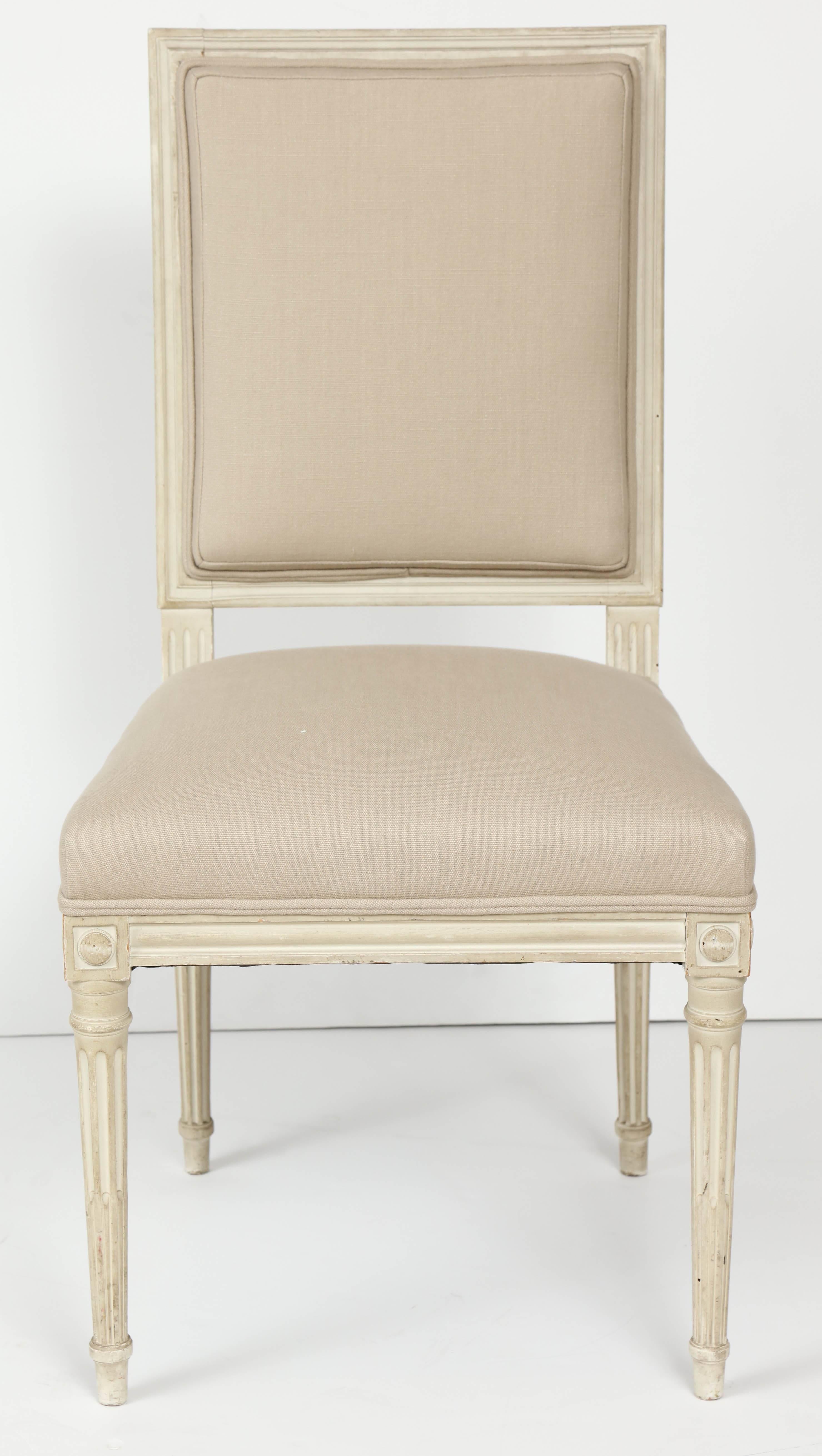 We love the understated elegance of these Louis XVI style painted dining chairs. Painted in a creamy white, the chairs display some of the lovely details characteristic of the Louis XVI style--square back and square seat, reeded, tapered legs and a