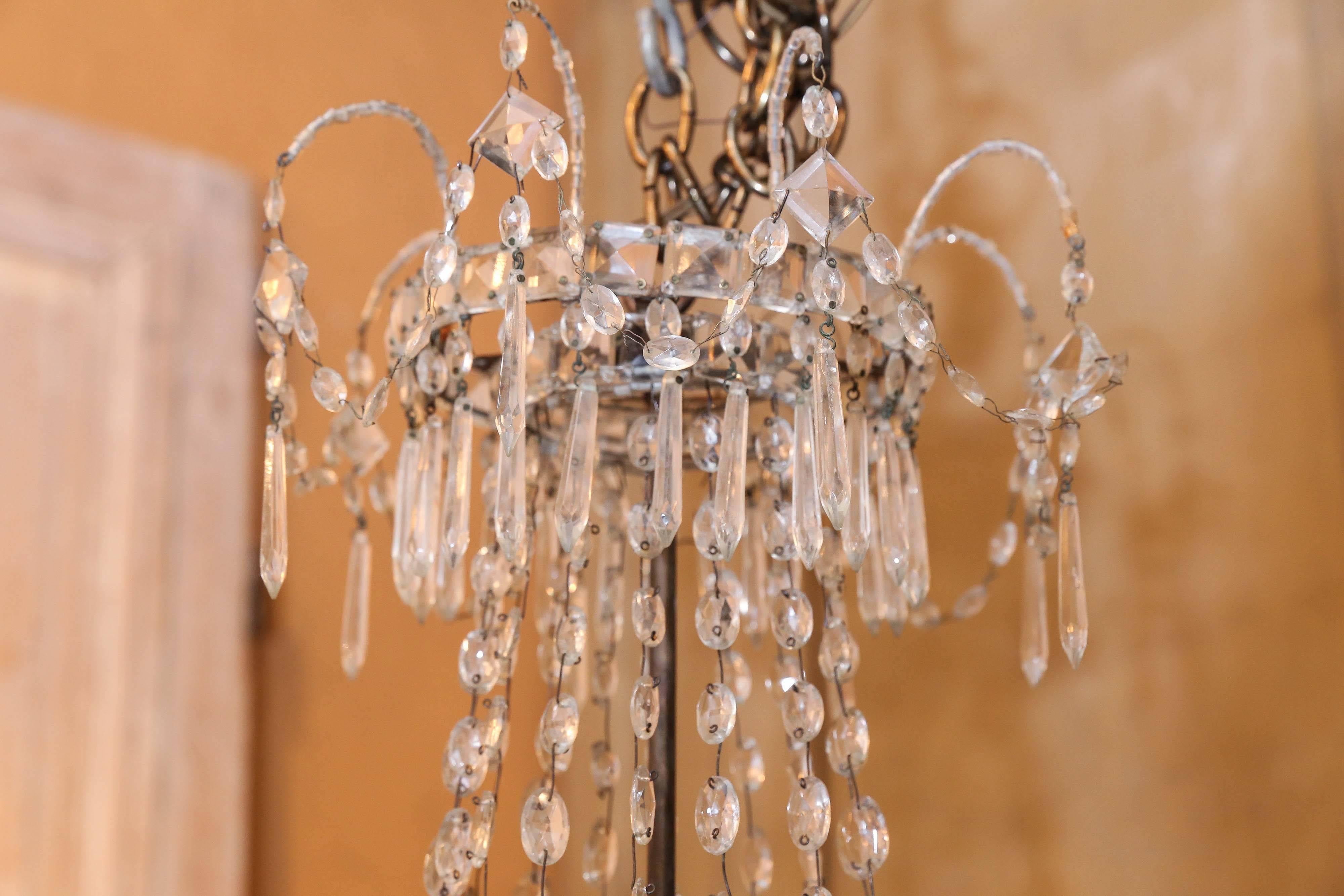 Empire style crystal and iron chandelier. Has been wired for the USA.