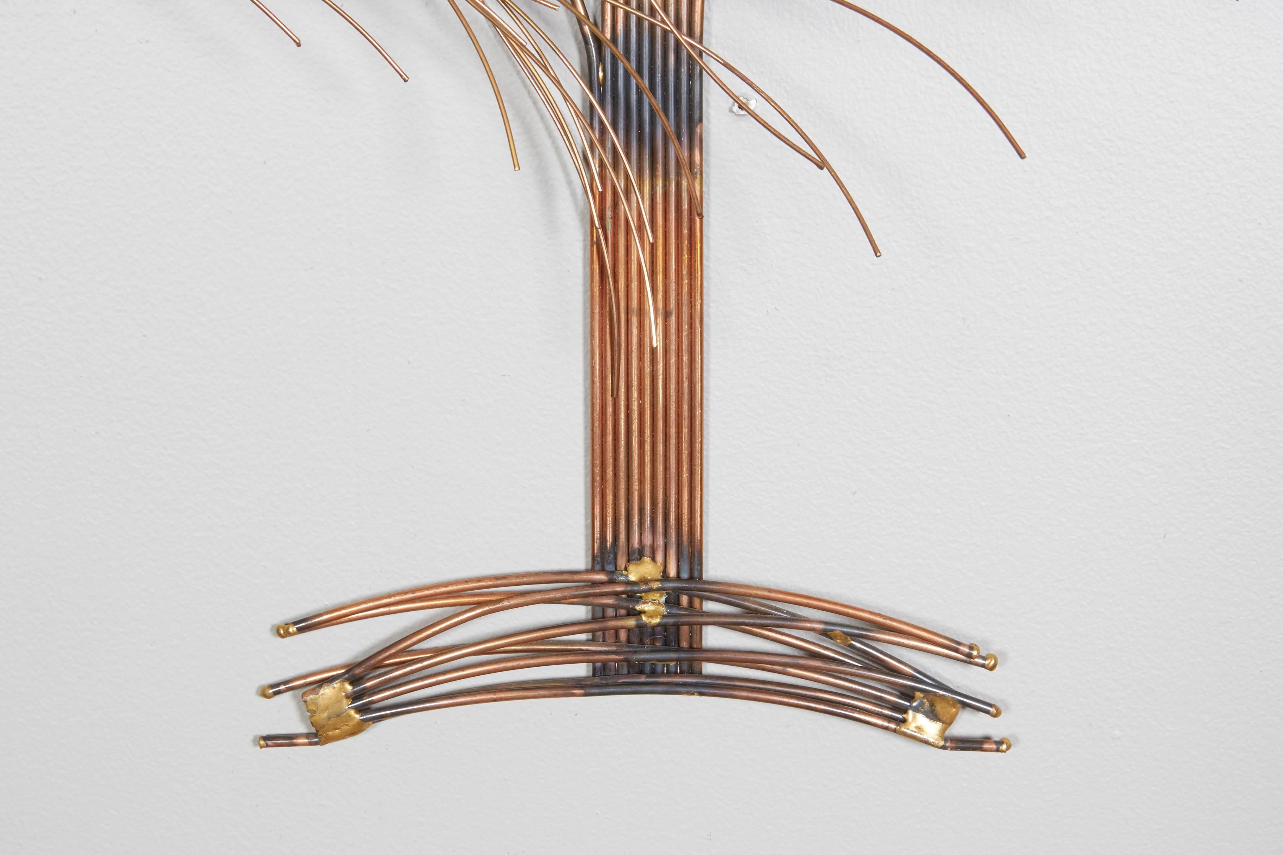 Curtis Jere wall-mounted sculpture, depicting a tree, comprised of welded and treated copper and mixed metals, it's branches depicted billowing in the wind, circa 1970s. This piece remains in excellent vintage condition, consistent with age and