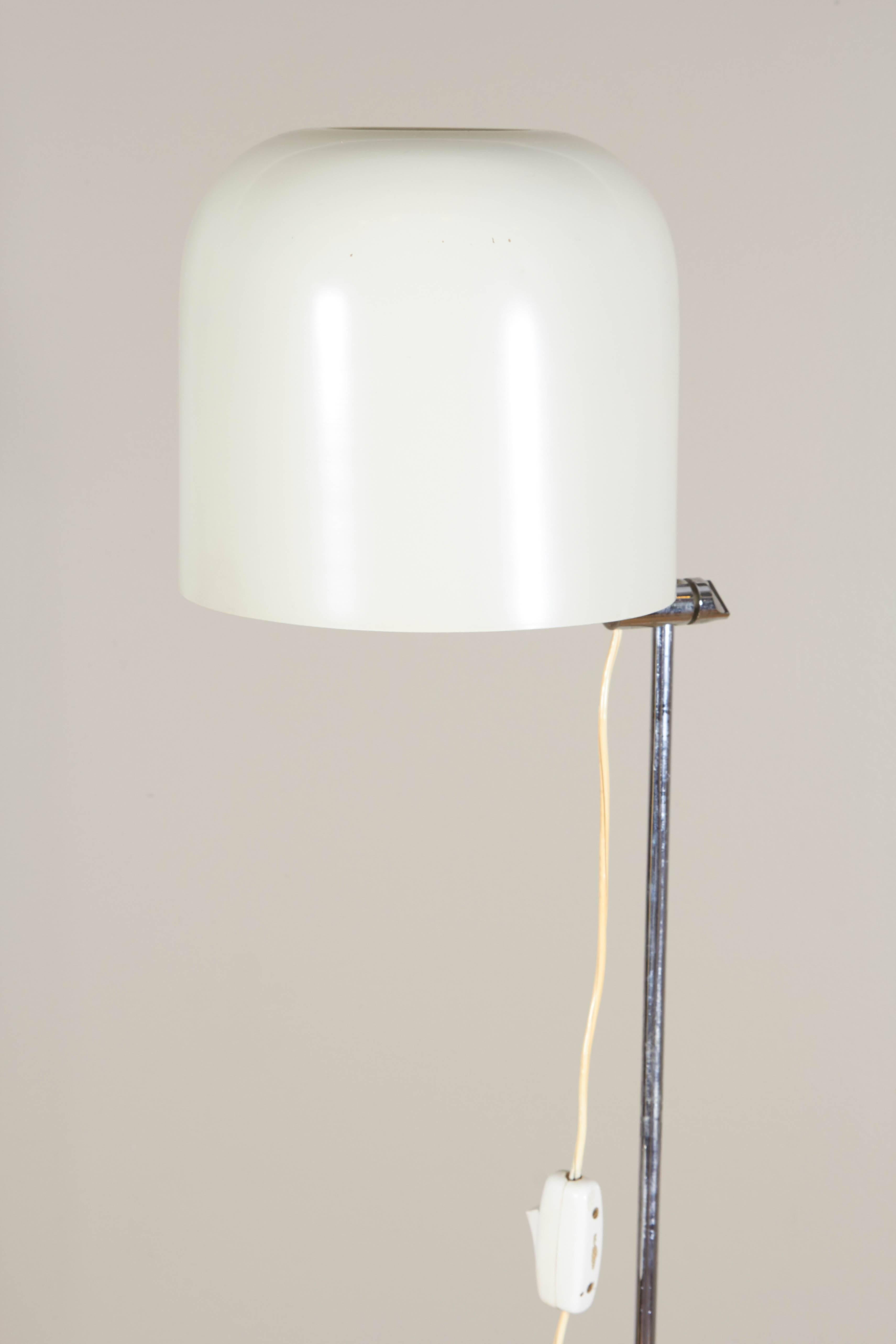 A modernist style floor lamp, manufactured in Spain, circa 1970s, with white enamel rounded shade, adjustable in height, on a chrome stem. Markings include sticker label [Made in Spain] to the shade. Very good vintage condition, wear to base