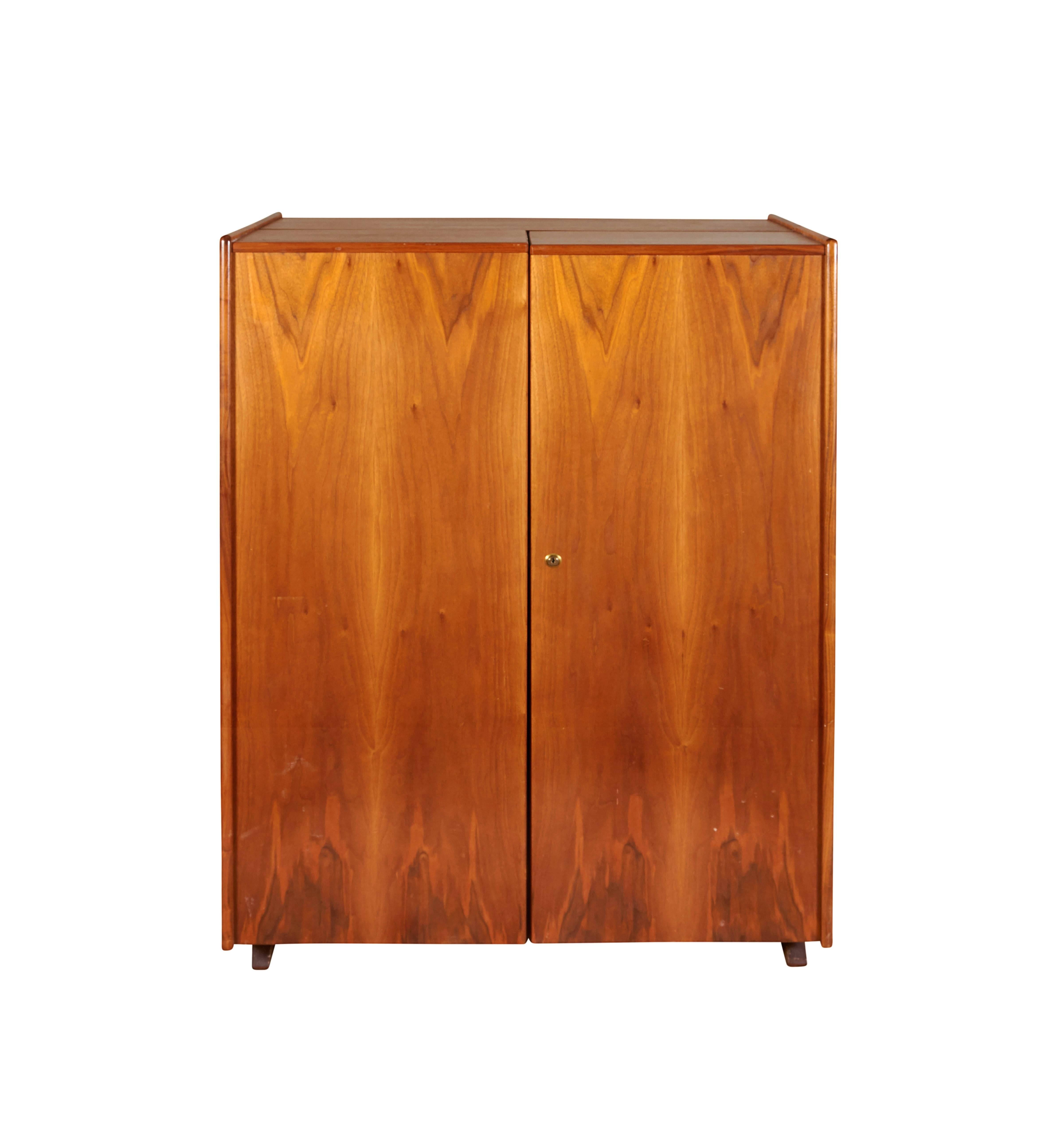 A multifunctional fold out secretary desk and cabinet, originally designed by Swiss architects Ernst Mummenthaler and Otto Meier, referred to as 'The 'Magic Box', manufactured circa 1960s, with numerous adjustable shelves, writing space with central