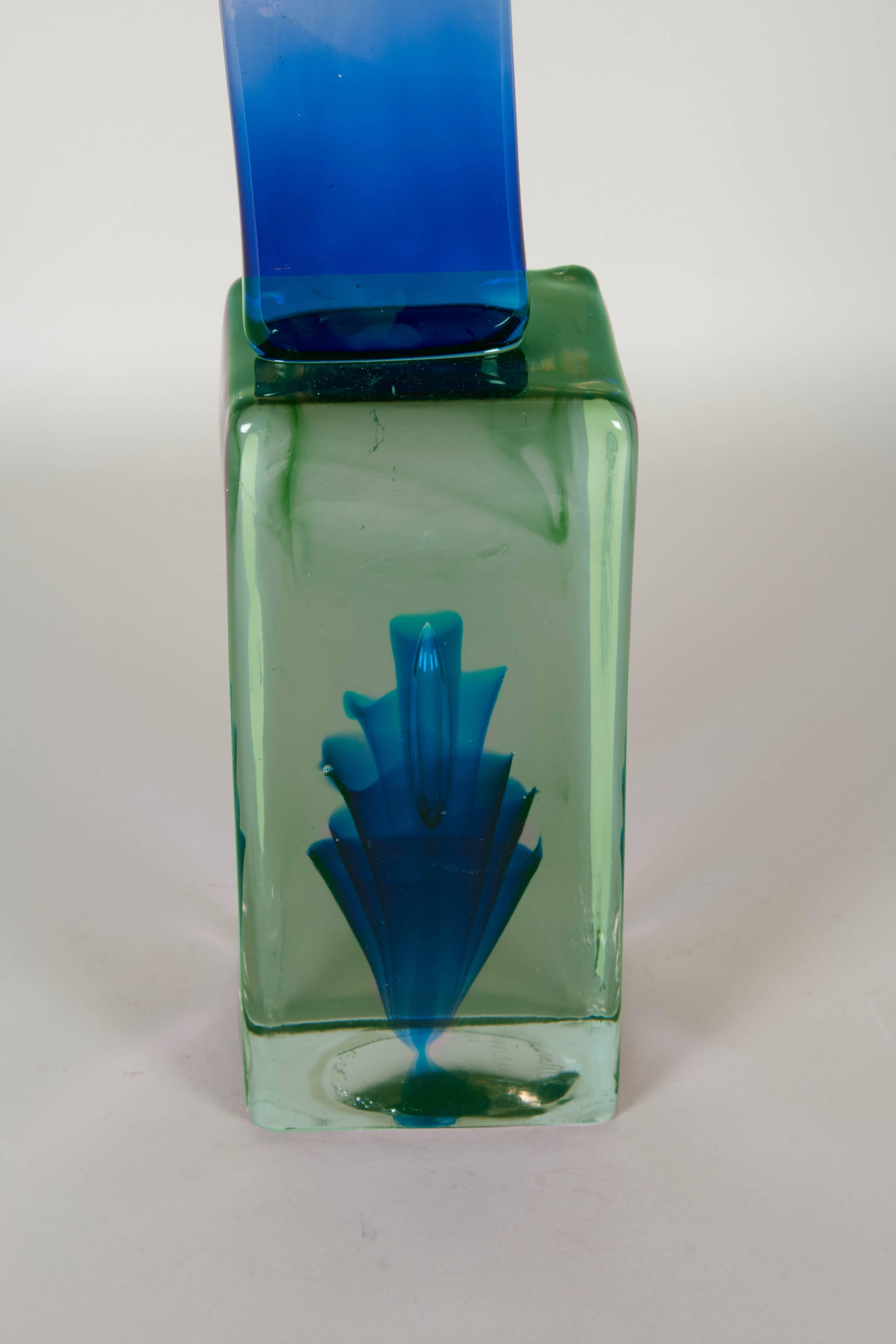 A modernist sculpture by Murano glass master Ermanno Nason (1928), comprised of three geometric forms, two in ombre shades, combining clear to teal and clear to blue, the largest at the bottom in green with swirls and decorative fanning. This piece