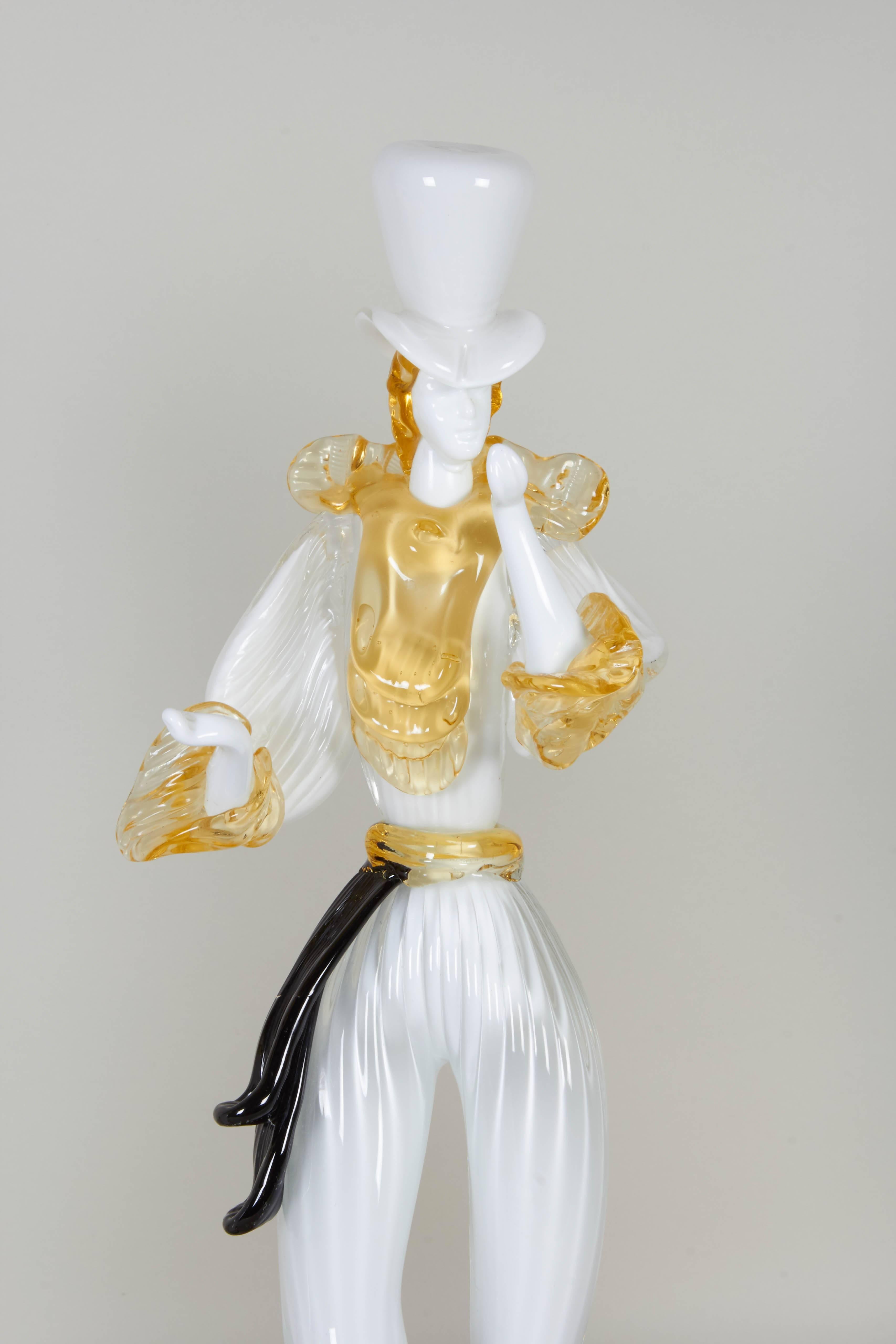 Italian figurines of a man and woman in blown Murano glass, produced circa 1960s, depicted in white and yellow, with highlights of black and purple, each elegantly dressed and posing gracefully. Includes original label [Formia/Vetri di Murano/Made
