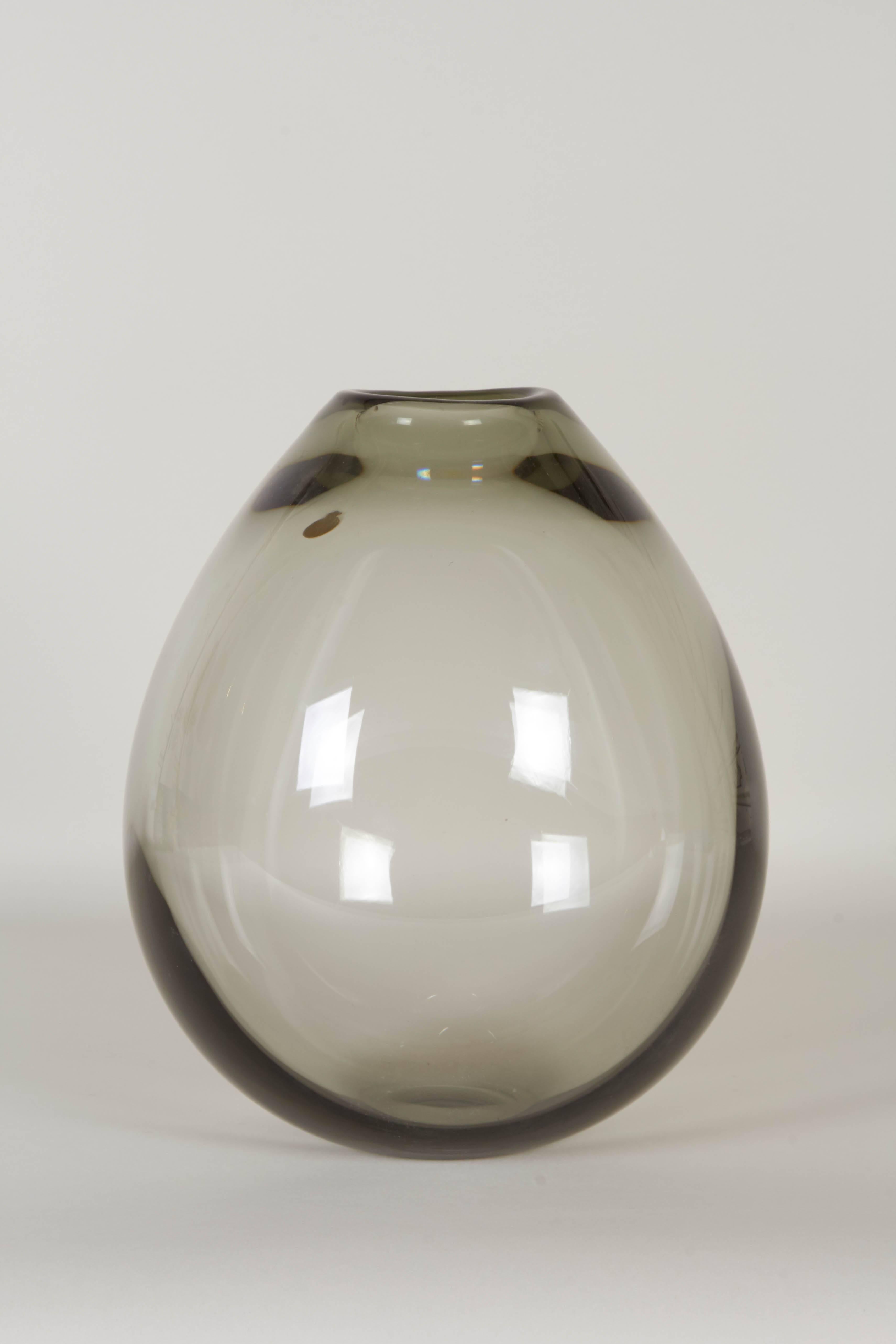 A 'soap bubble' vase in handblown smoked glass, produced circa 1960s by Danish glassmaker Per Lütken for Holmegaard. Markings include original Holmegaard foil label, signed to bottom. Excellent vintage condition, consistent with age and use.
