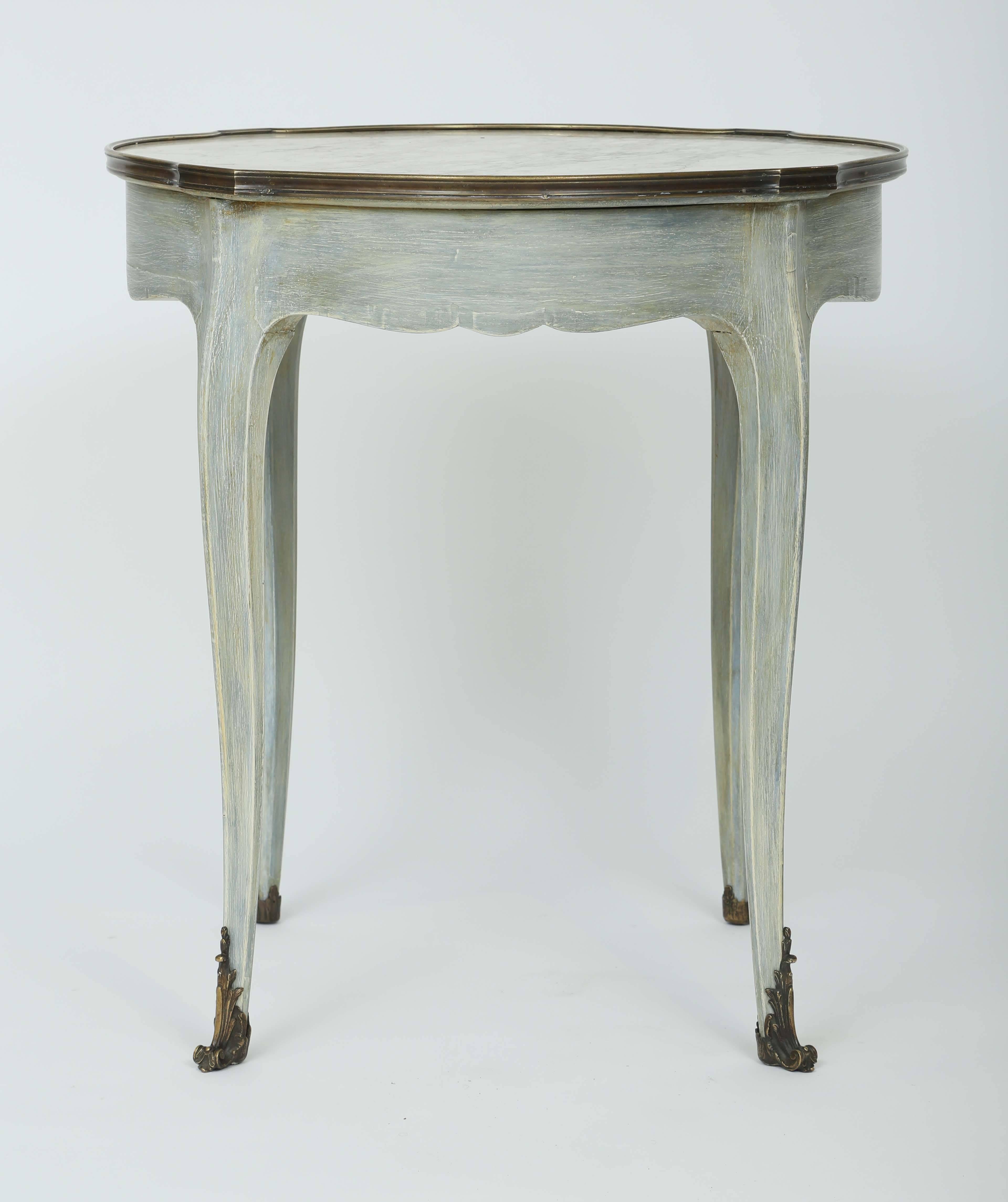Occasional table, of painted walnut, having veined marble top inset in raised bronze frame, single frieze drawer, raised on cabriole legs terminating in bronze scrolling acanthus sabots. Label in drawer: 