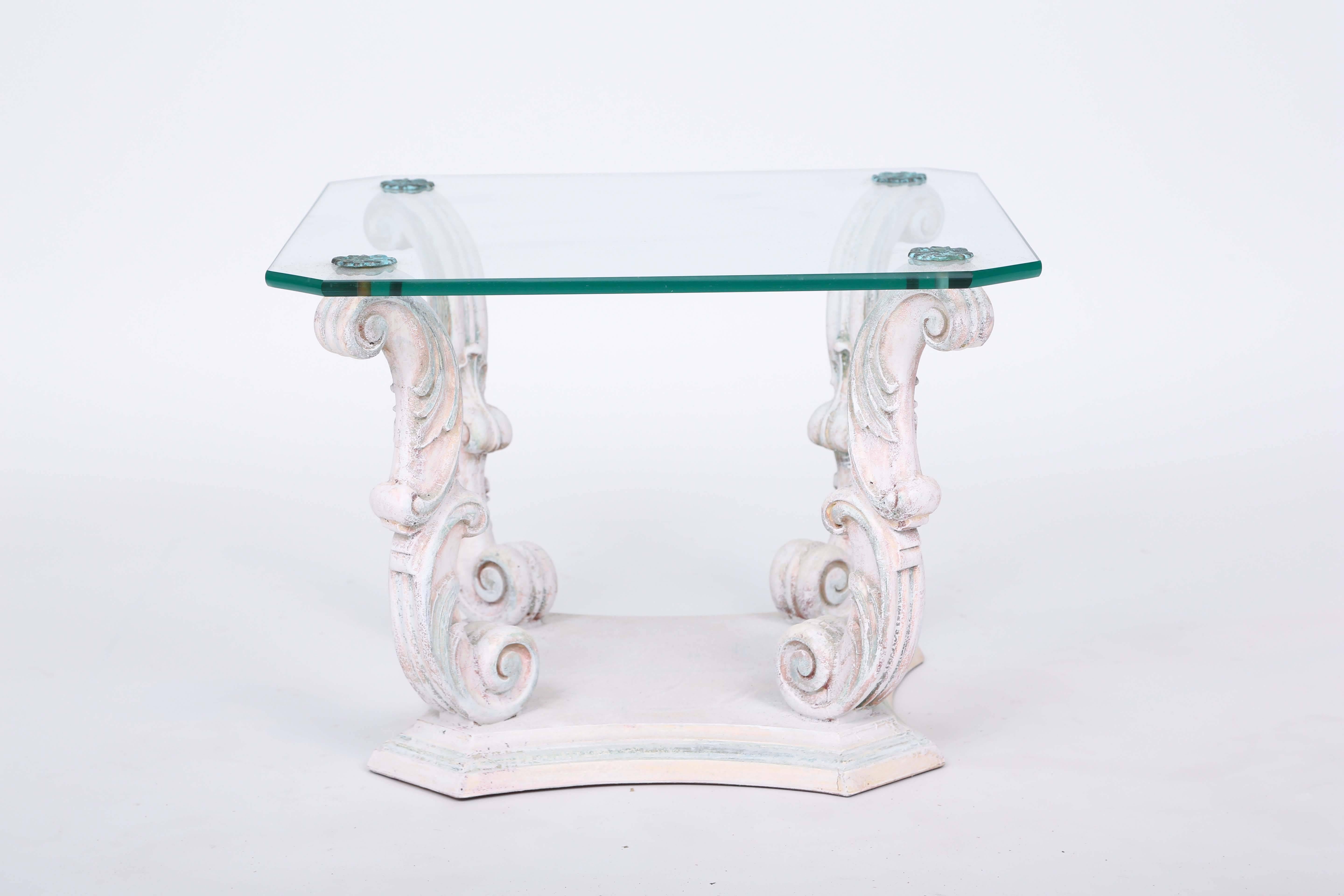 Pair of side tables, with painted finish, each having a square top with canted corners, of glass, raised on four double scrolling legs, on graduated plinth with concave sides.

Stock ID: D9380
