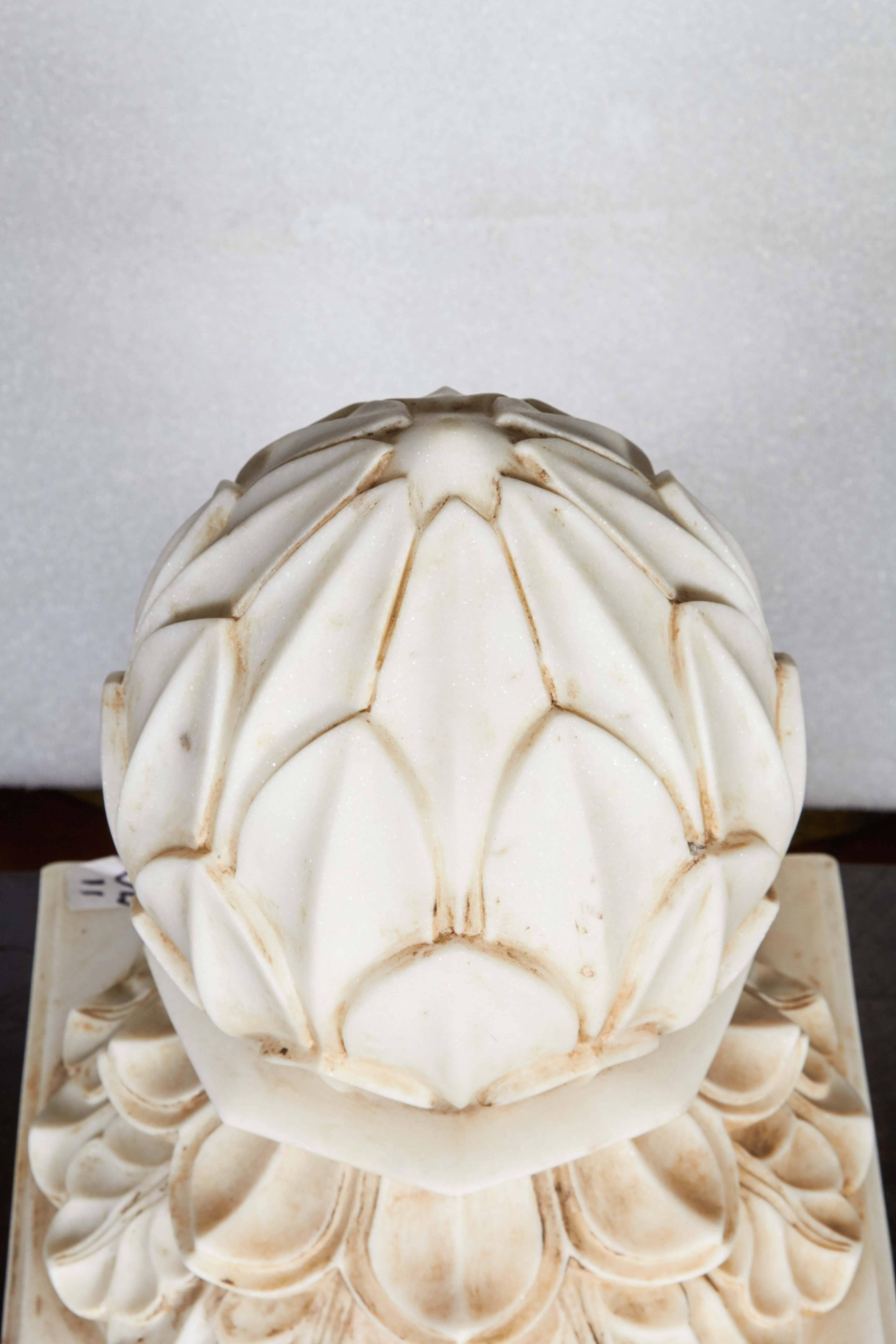 A large carved white marble carpet weight from India in a Classic lotus blossom style. Can also be used as a decorative element for patios, gardens or decks. 