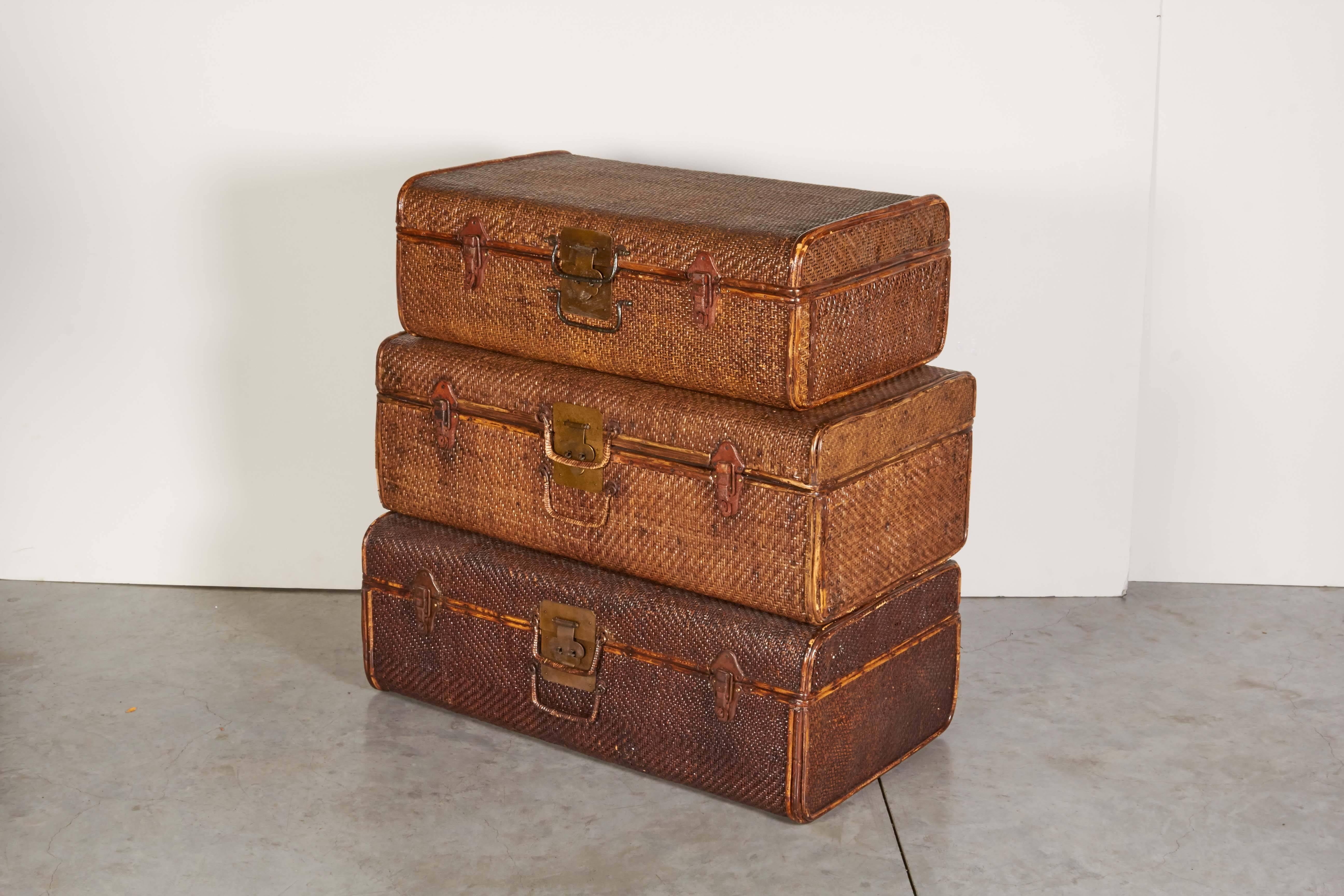A collection of three handmade rattan suitcases with beautifully finished wooden interiors. All in great condition. These work great as coffee tables, side tables, and storage pieces in addition to being highly decorative objects.
CST101.