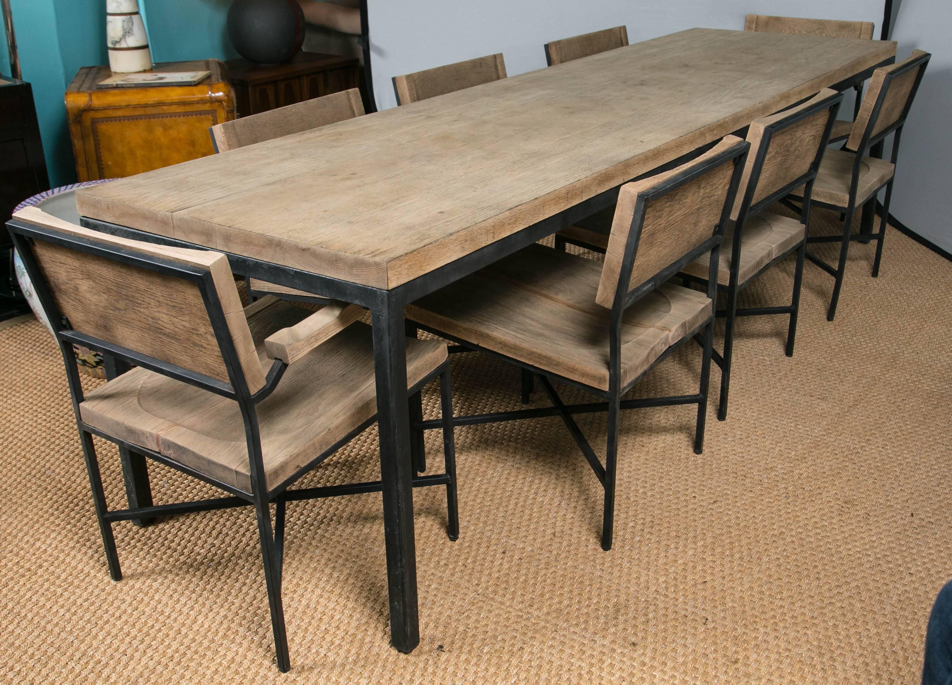 Attributed to early Knoll/Drake when Knoll collaborated with Drake Manufacturing of Texas. A rare set of a solid wood table, two armchairs and six side chairs supported by an iron frame.