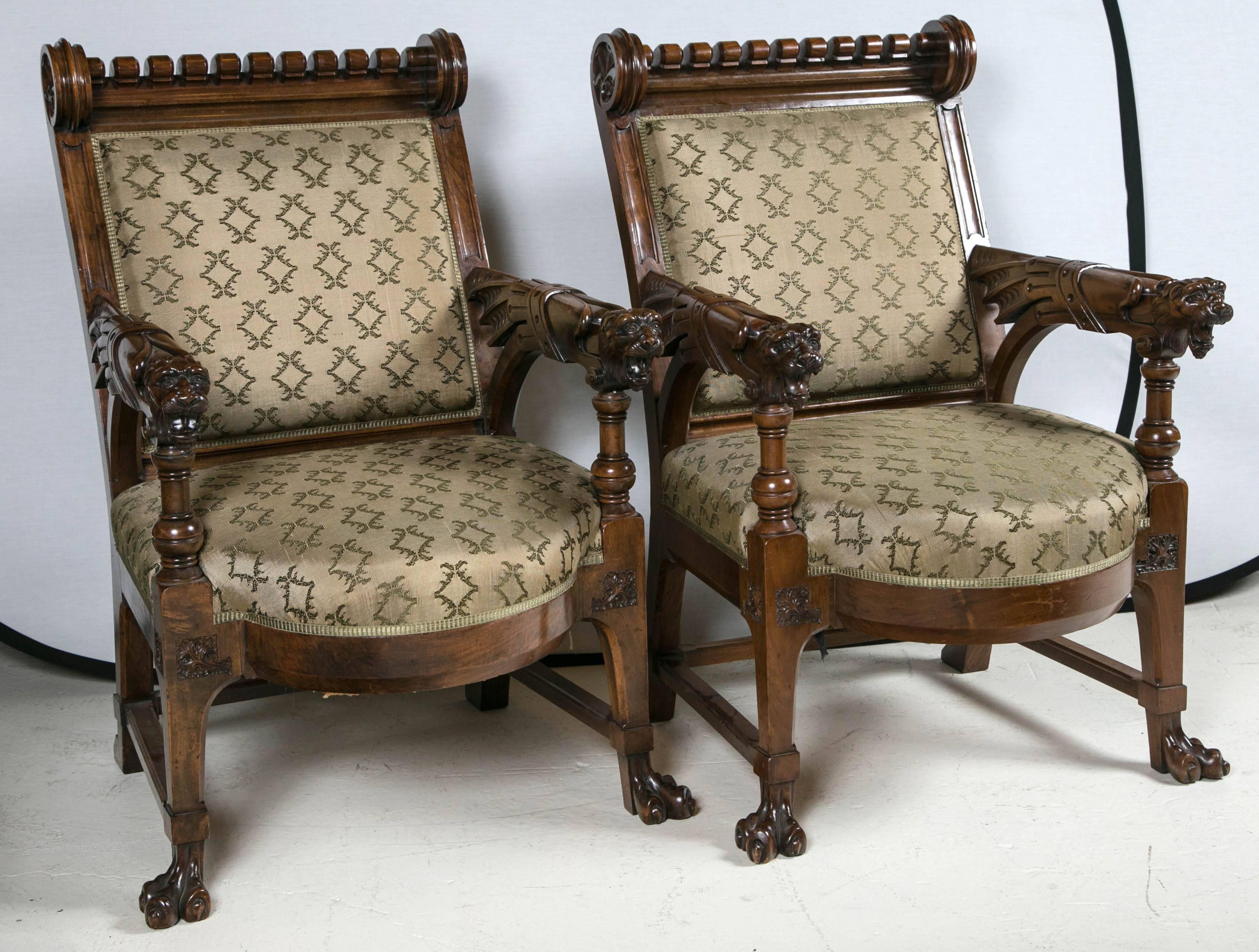 Pair of Renaissance Revival walnut chairs, with carved lion armrests, 
and carved claw feet.

  