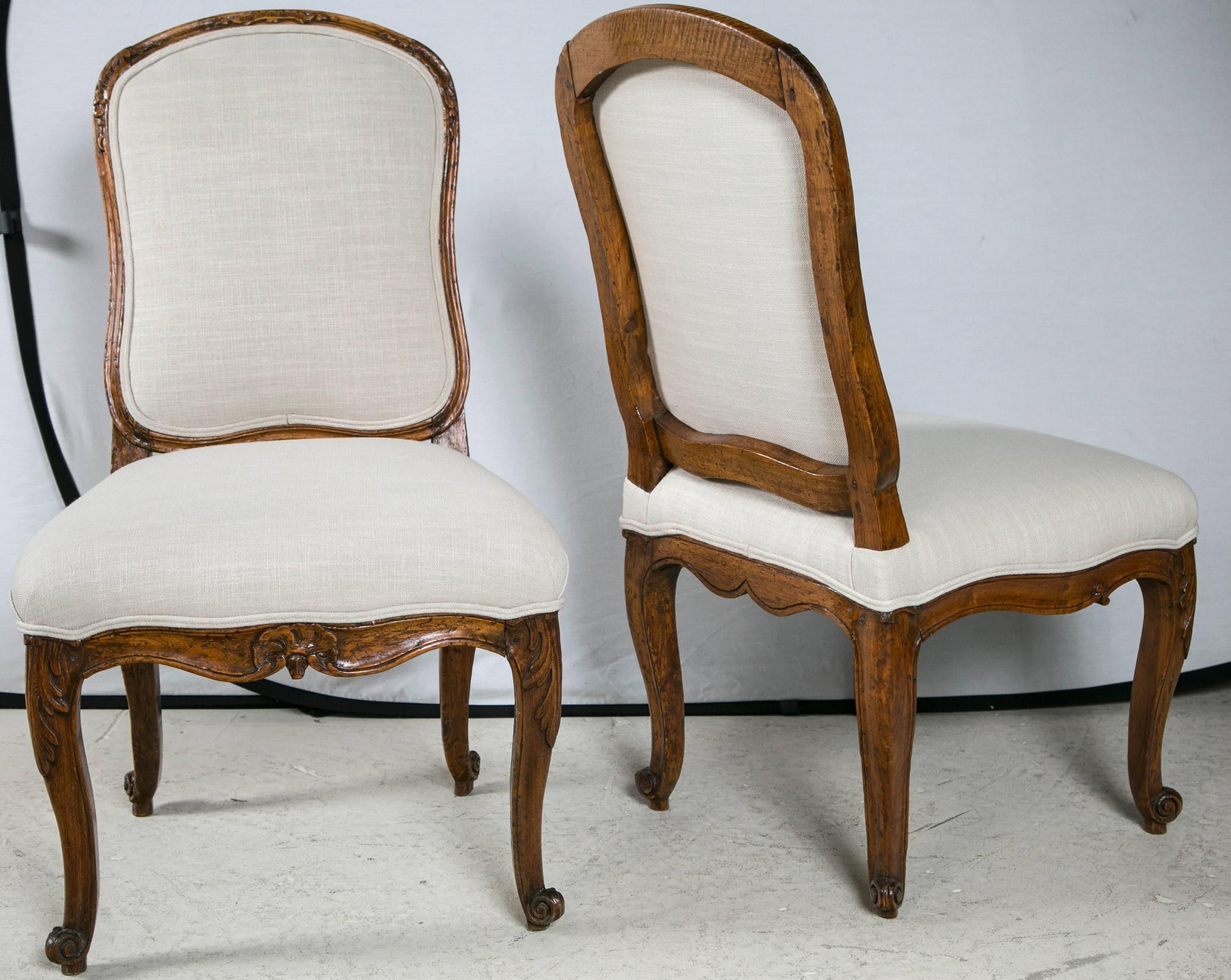 Pair of 18th century French walnut chairs upholstered in linen.