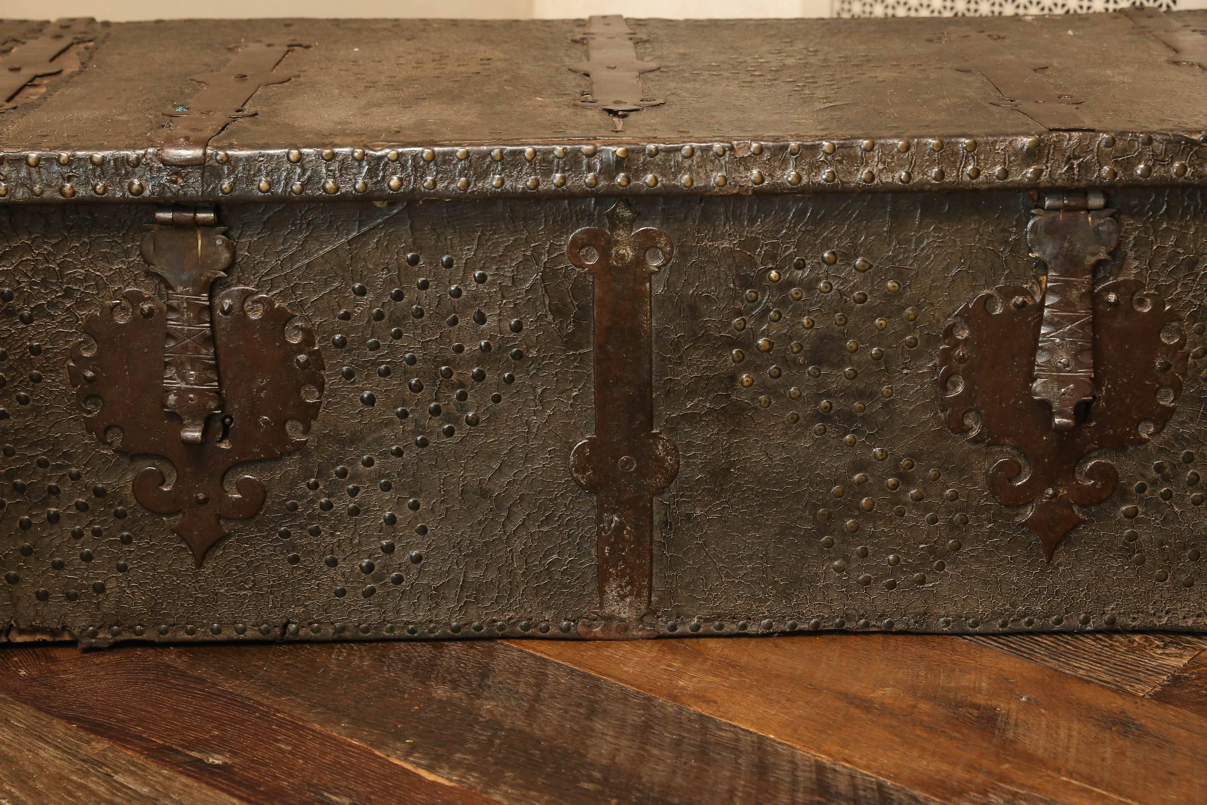 Late 16th century Spanish leather trunk with original hardware and brass tack designs.