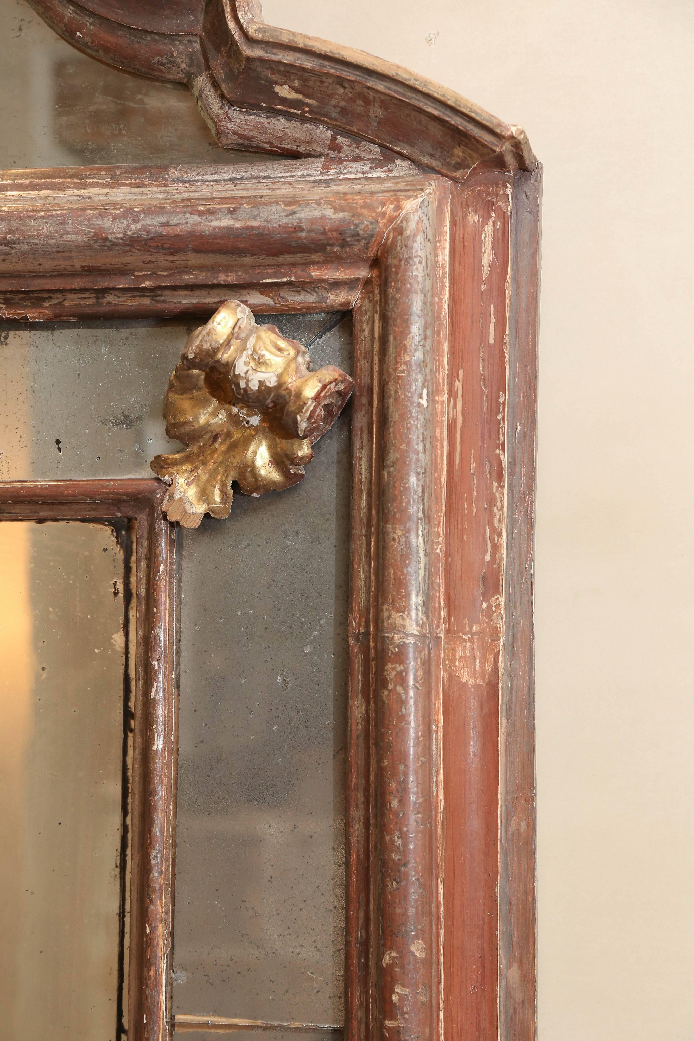 18th century Venetian mirror form a 16th century palazzo in Tuscany. There is a crack in the left corner as detailed in the photograph. Beautiful gilt details and mercury glass mirror. This is one of a pair.