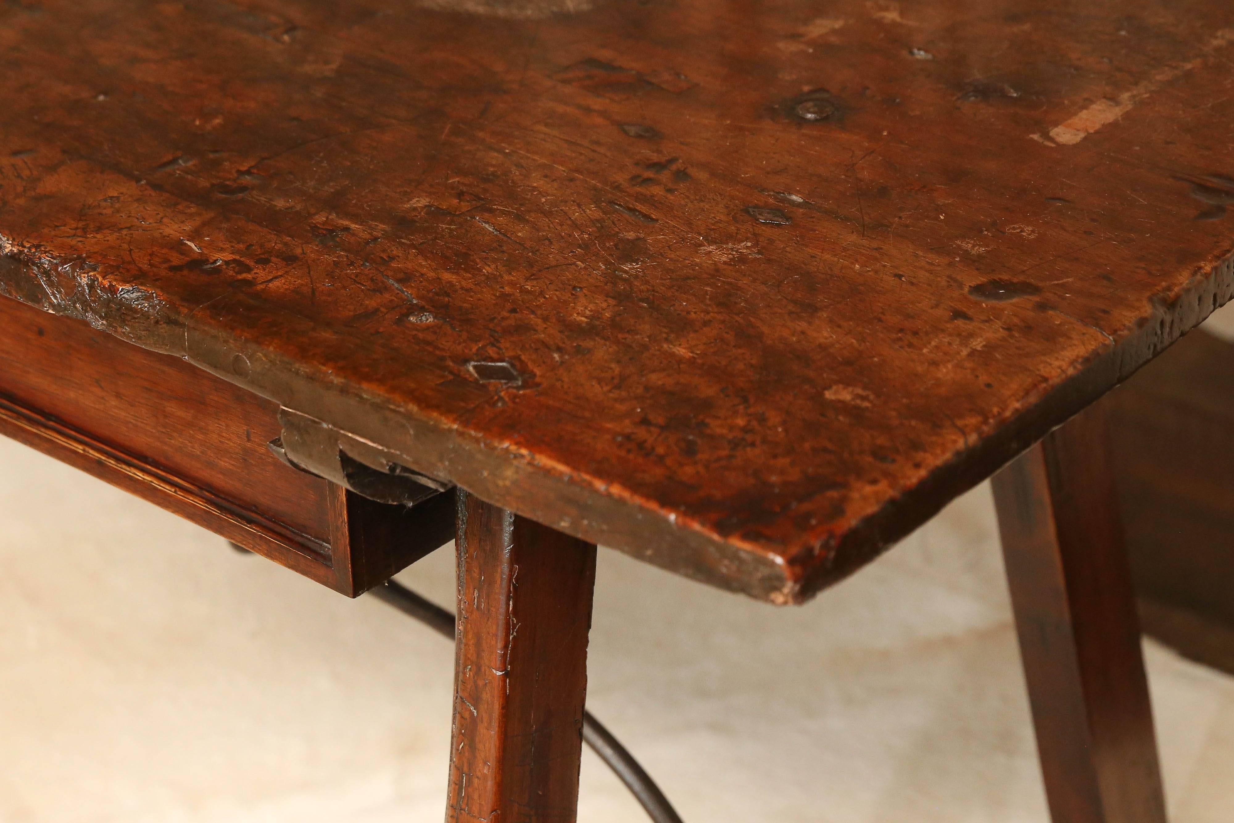 18th century Spanish table, in the San Antonio style, with iron straps has been modified to function as a desk with two drawers. Beautiful patina, sturdy.