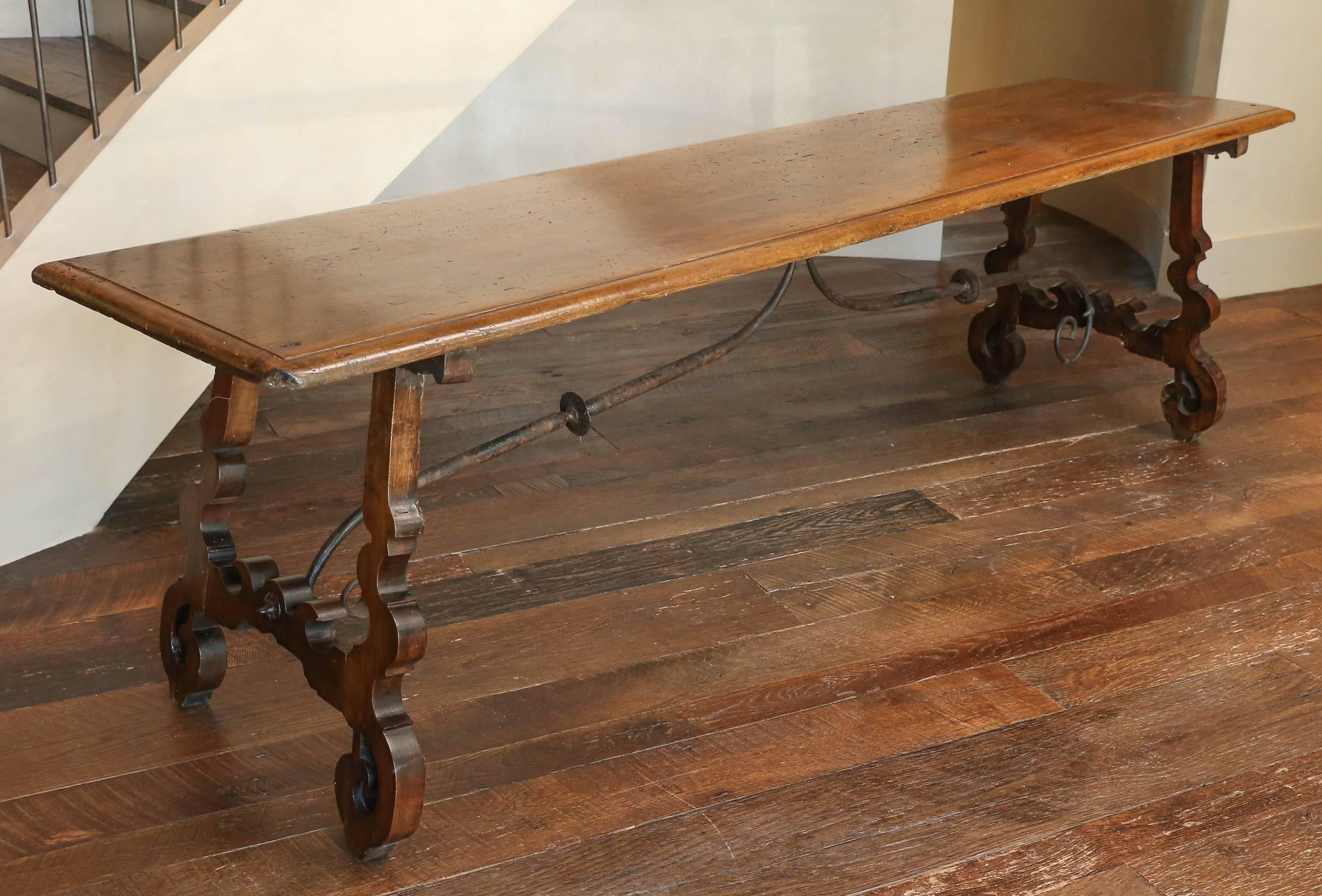19th century Spanish single plank table with beautifully carved legs and hand-wrought stretchers. Spectacular patina.
