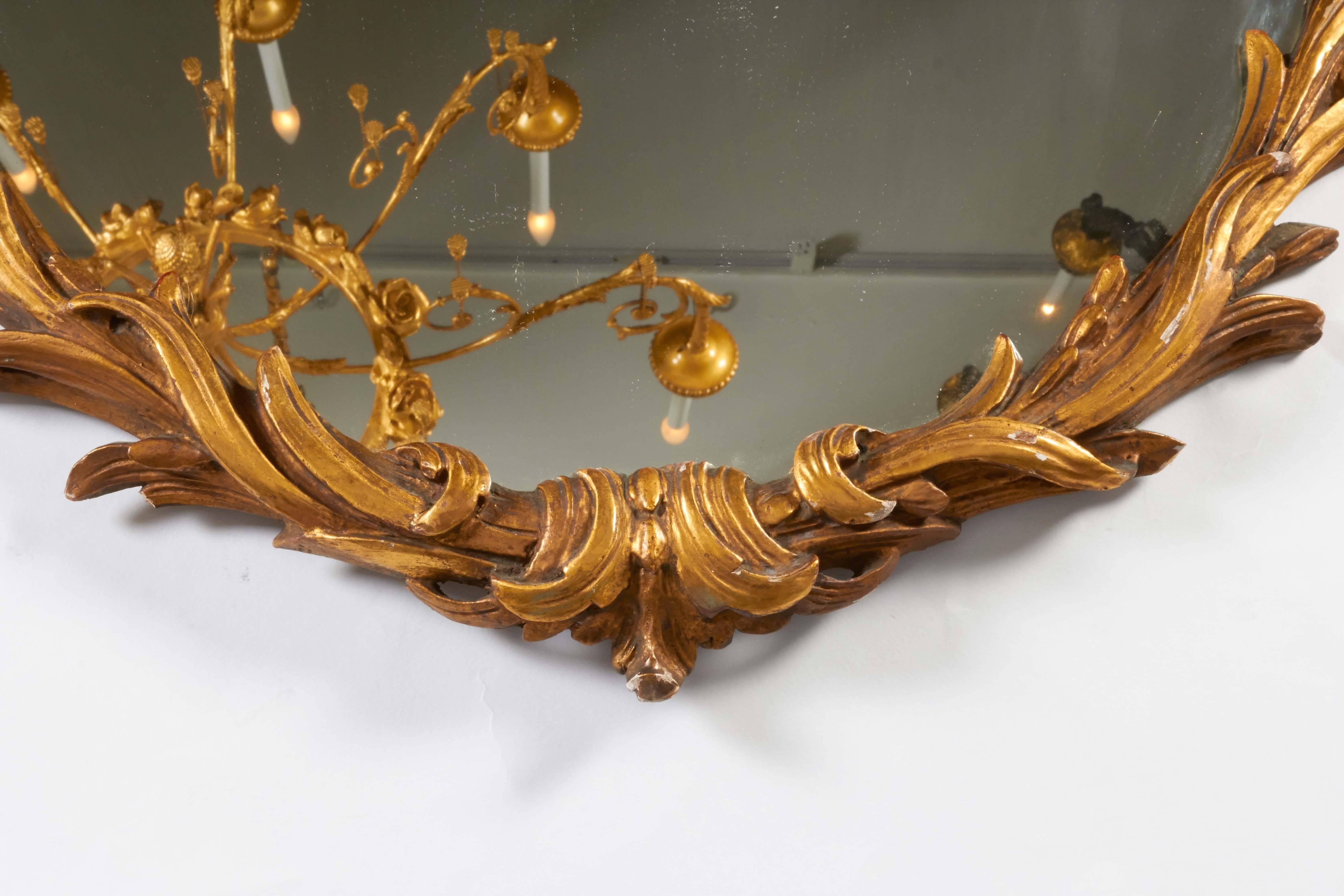 A pair of Louis XV Rococo style hand-carved giltwood mirrors.