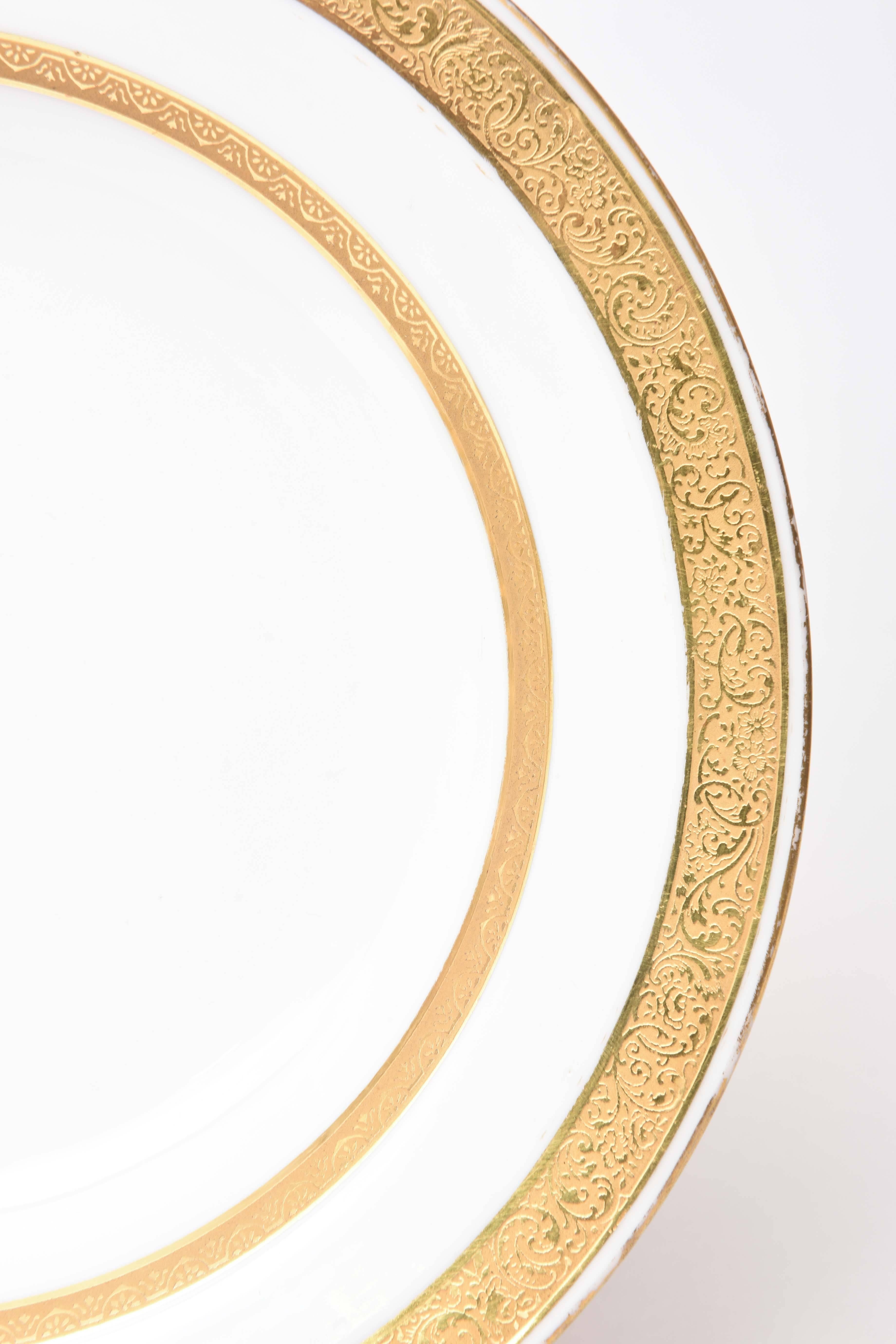 Always a need! A set of 12 rimmed soup bowls perfect for soups, pastas, salads and desserts. Custom ordered through Tiffany's at the turn of the last century and highlighted with two acid etched gilt bands. Simple and elegant and ready to mix and