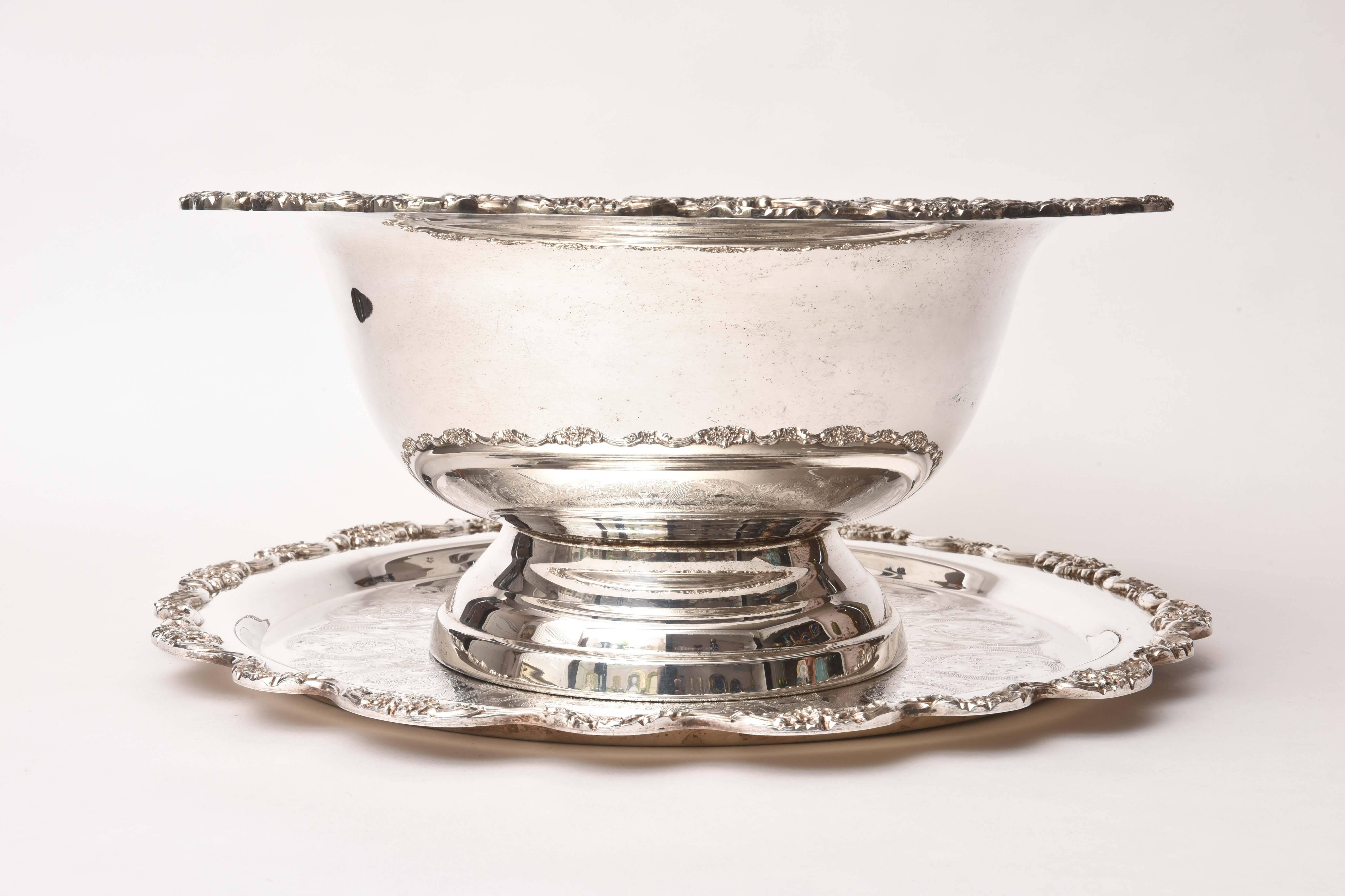 A fantastic punch bowl or centerpiece produced by the American silversmith company: Towle. In really nice vintage condition with no damage or silver loss. A pretty scalloped shape on the border and nicely etched design. It is large in size and would