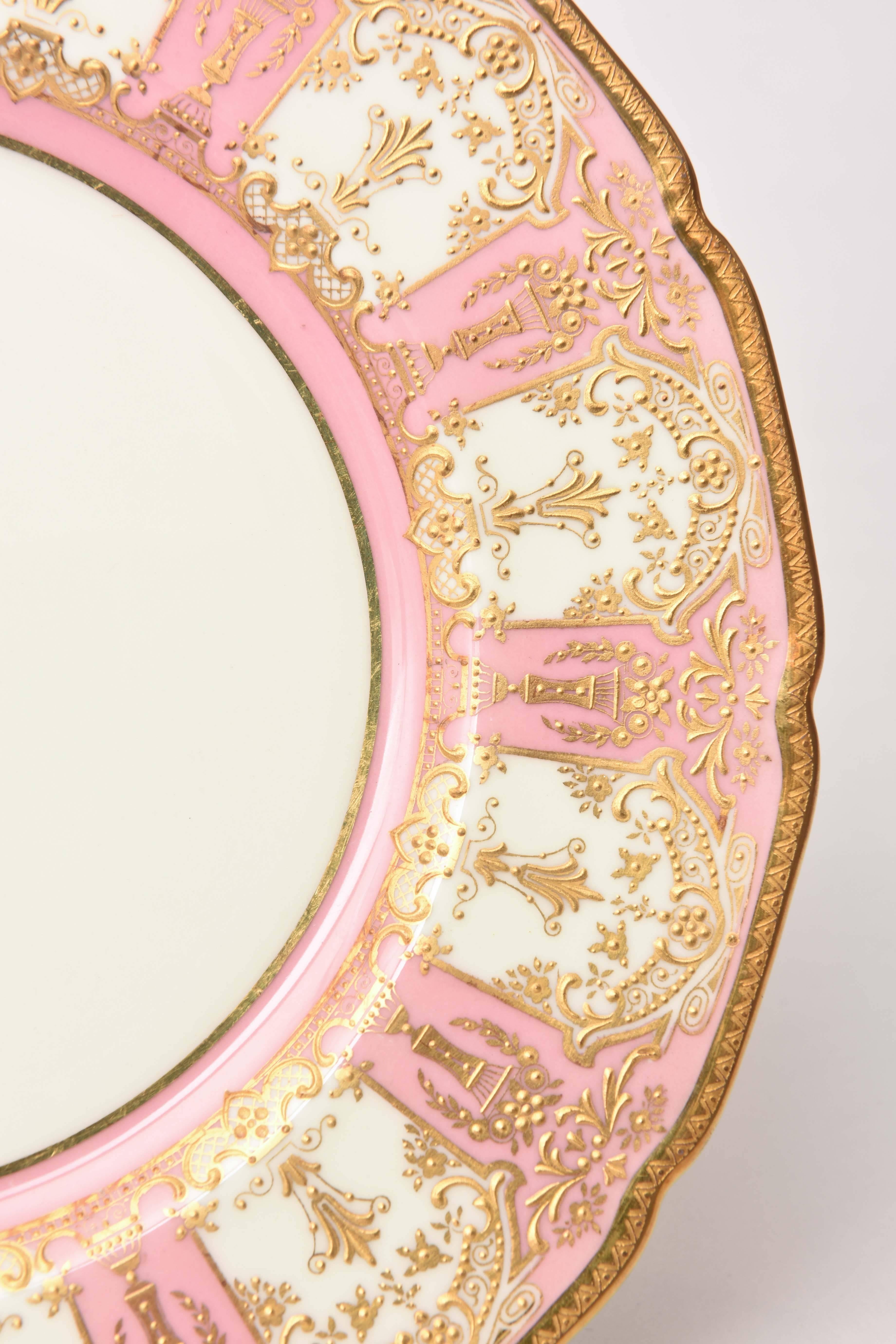 Retailed through Tiffany, here is one of our favorite sets of antique plates by Royal Doulton featuring their Classic shape. Detailed urn and floral raised paste gilding on a soft and pretty pink shoulder. Perfect for mixing and matching in with all