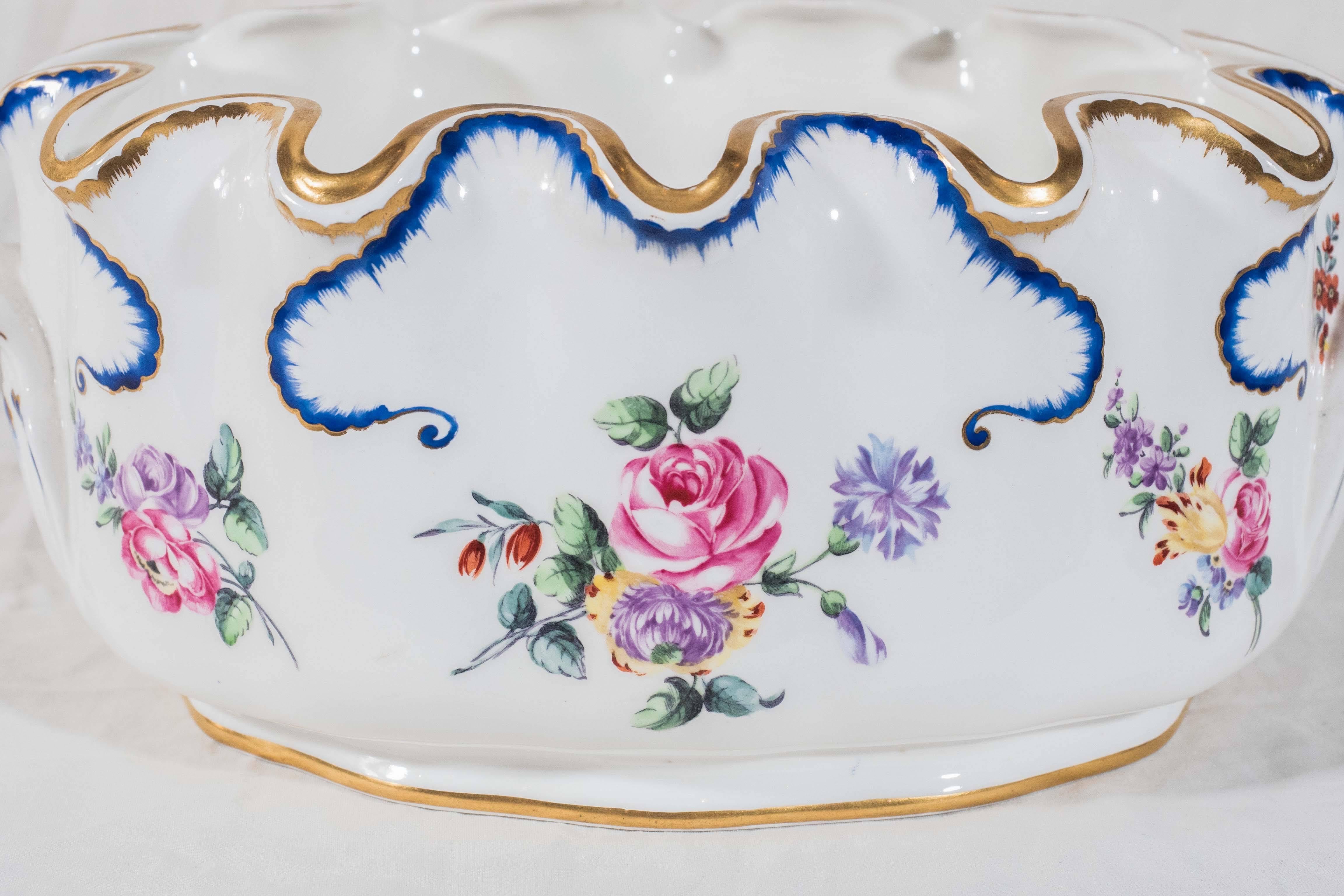 A continental monteith hand-painted with peonies and other flowers in the Feuille de Choux pattern. This form was used in the 18th and early 19th century as a wine glass rinser. Today this piece would be a lovely addition on any table planted with