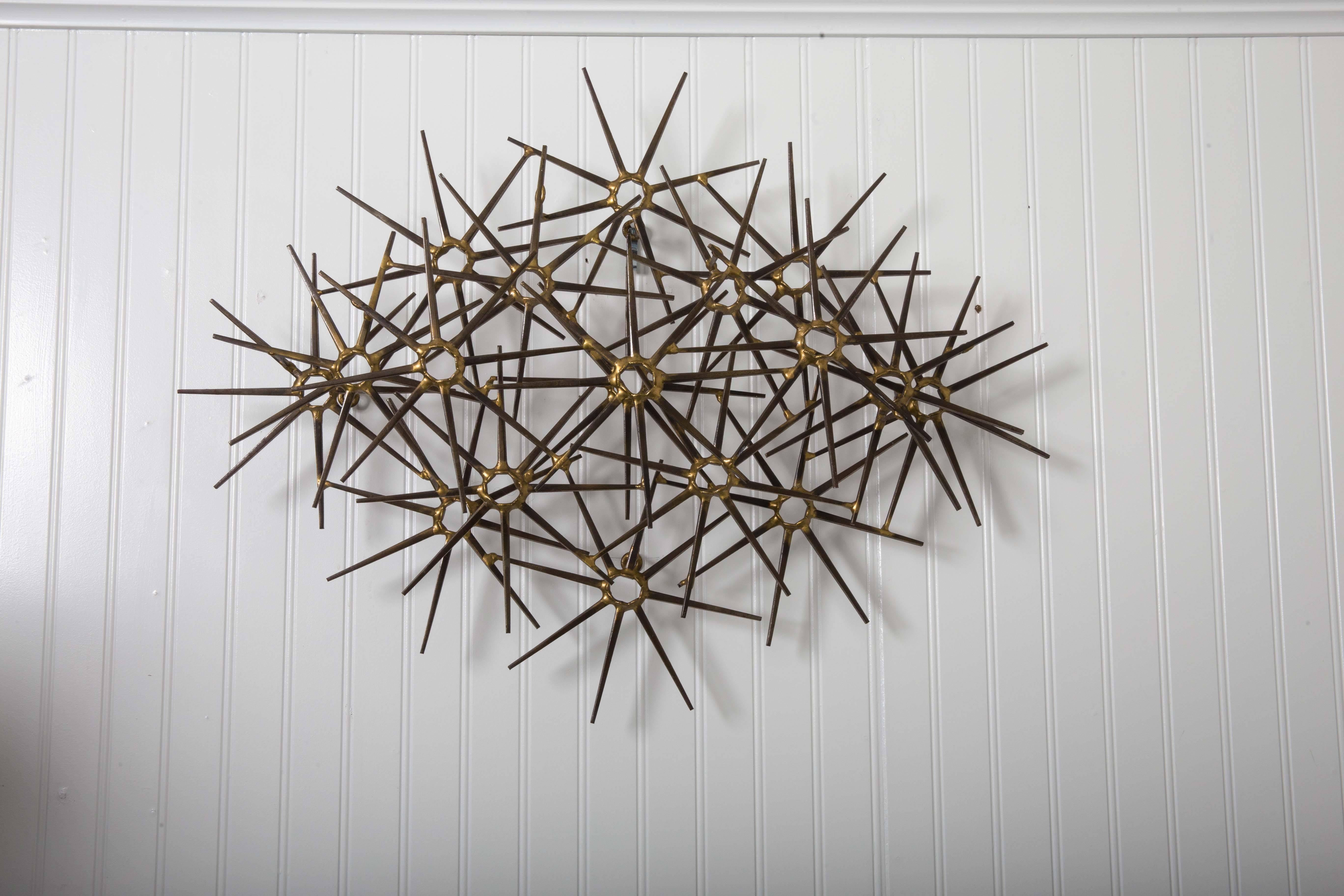 Decorative artist's wall mounted sculpture, circa 1940s-50s. Made of steel and brass.
