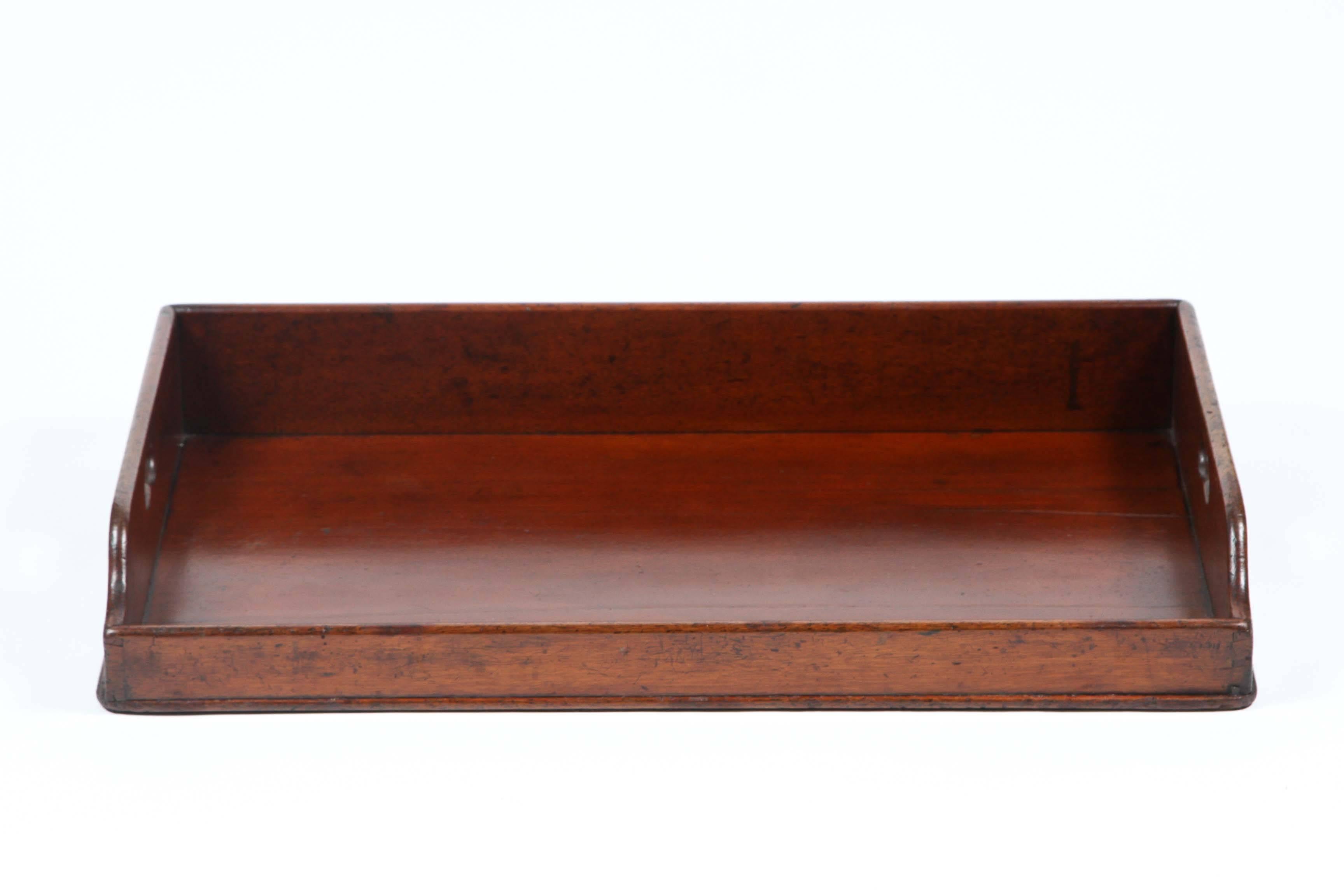 An oversized mahogany butler’s tray, circa 1860. Perfect on an ottoman!
 