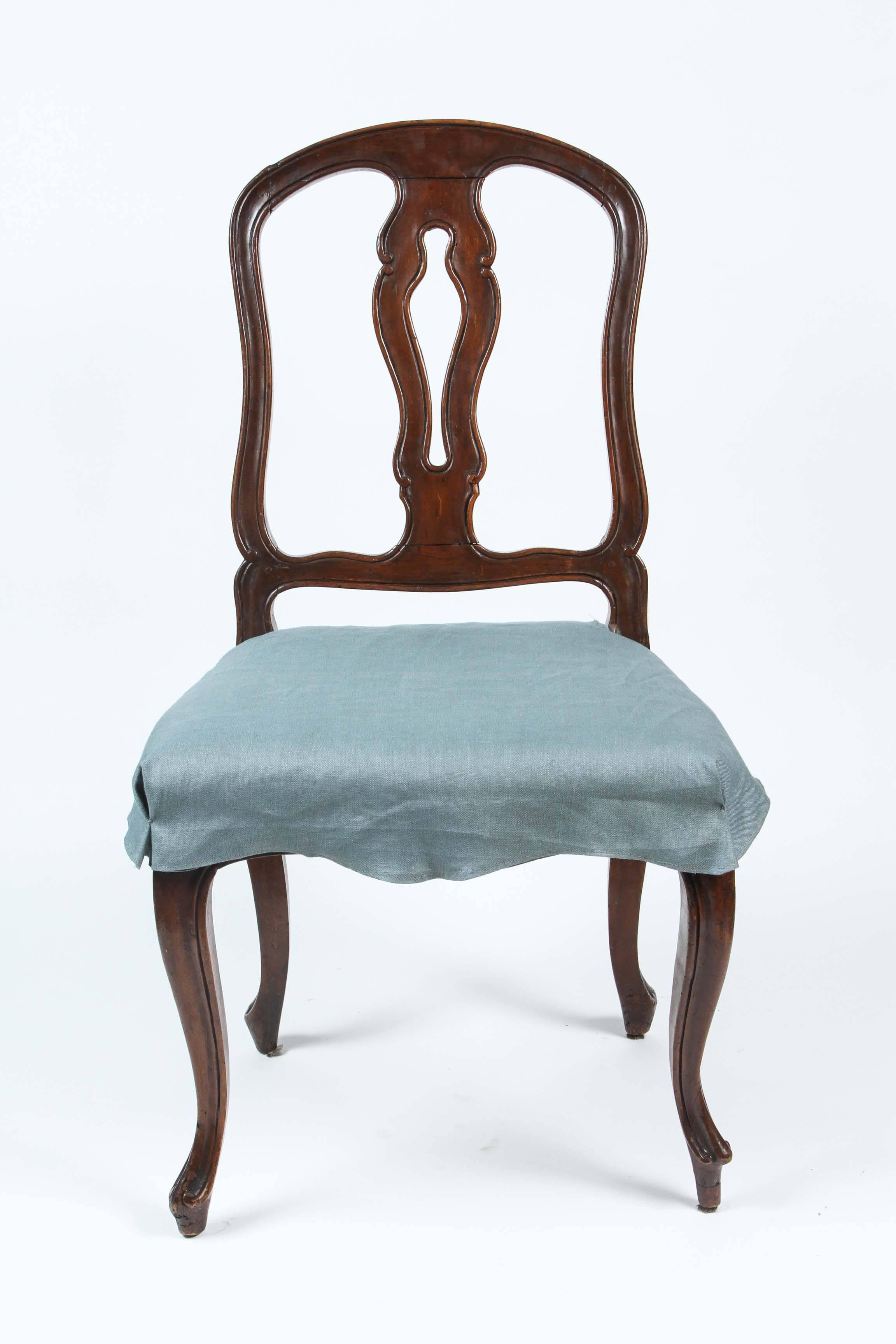 A charming set of four Italian Rococo walnut side chairs, circa 1770. With custom, removable linen seat covers.
 