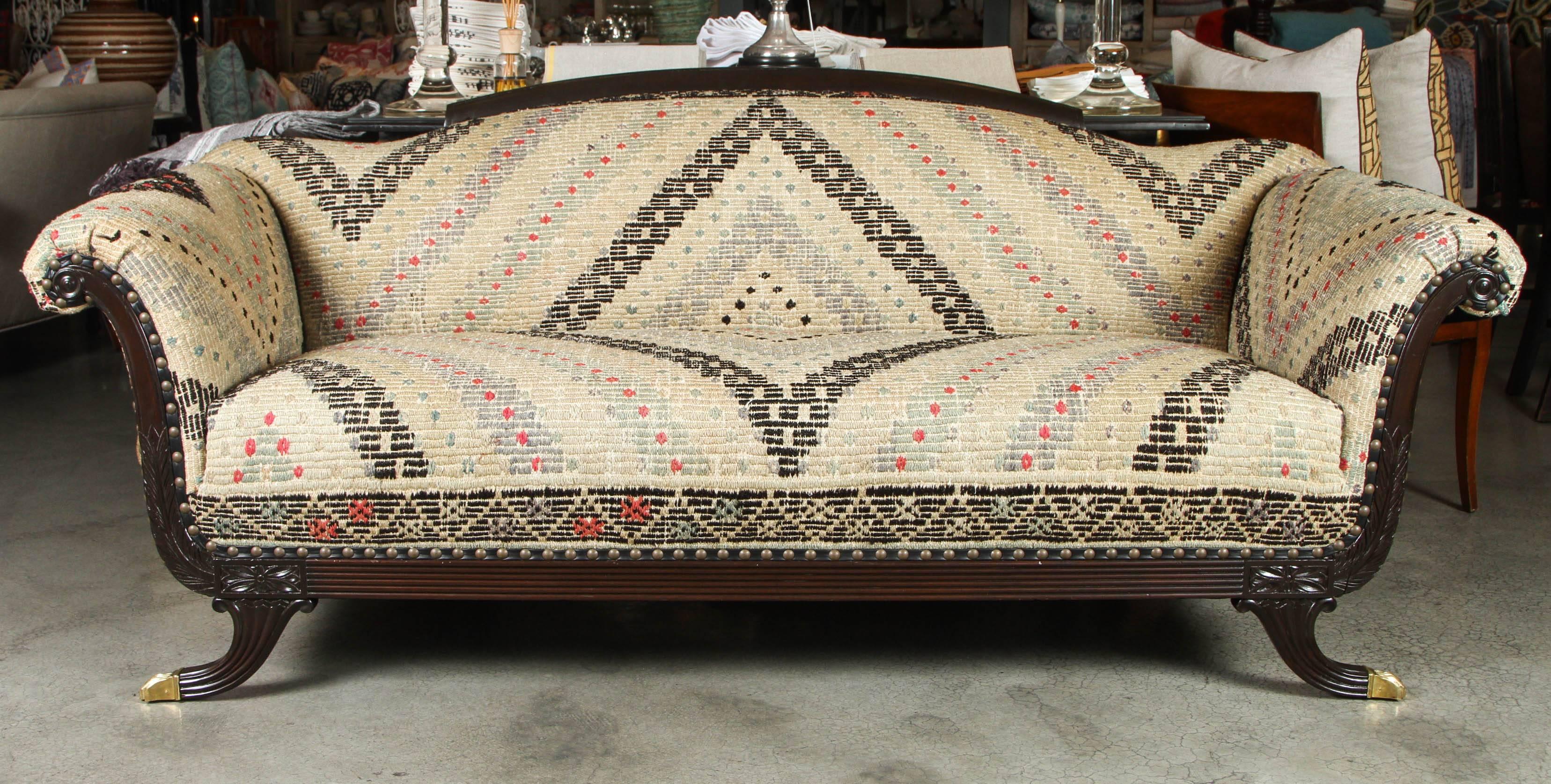1930s Duncan Phyfe style sofa. The walnut frame is newly refinished and original brass feet are newly polished. All new upholstery in vintage cotton/wool Oushak Jijim rugs from Turkey in an antique/vintage wash.

Seat Height 18
