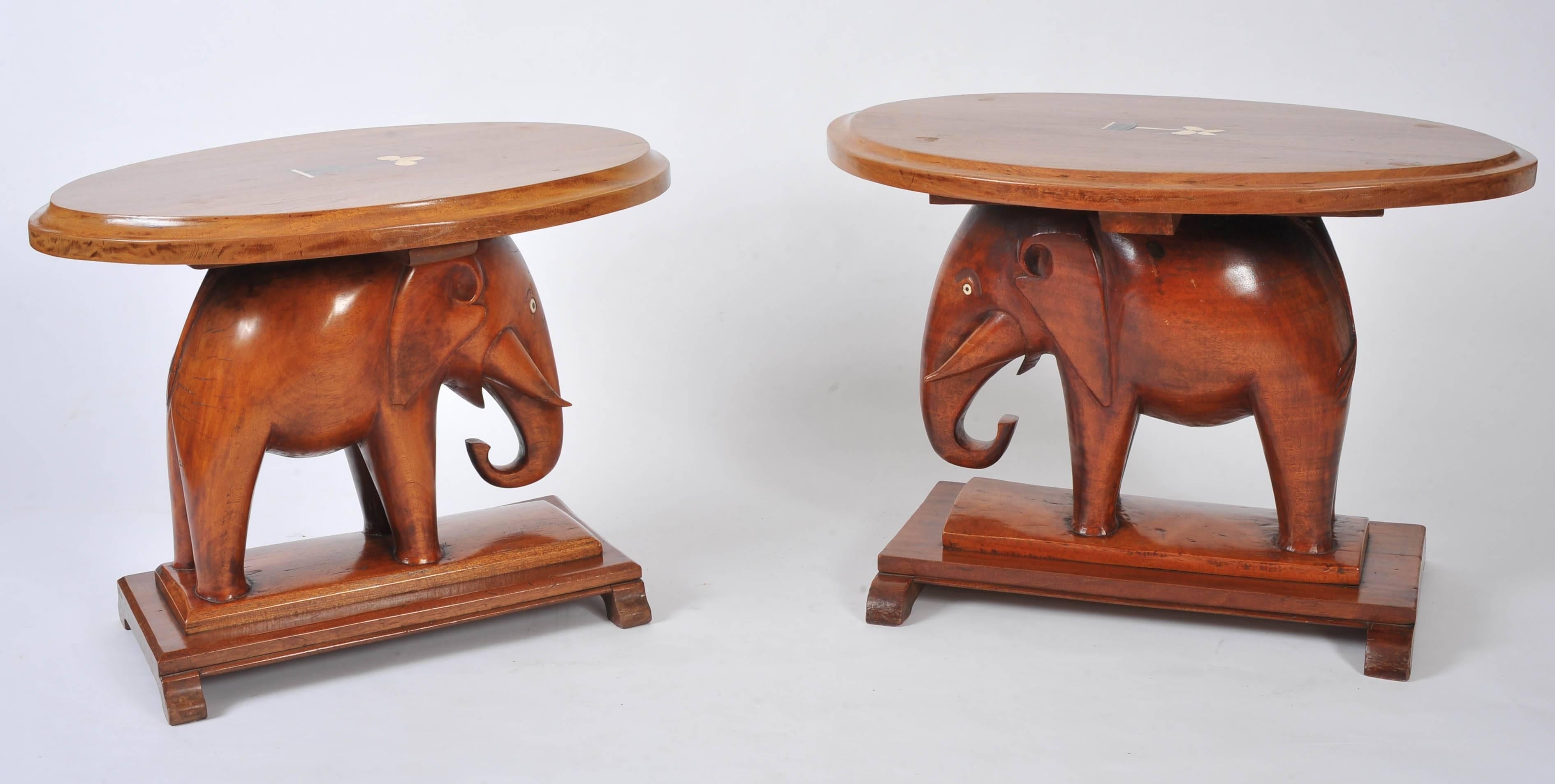 These very decorative carved elephant side tables features an oval top with an inlaid central bone floral design. Each table measures 23 in – 58.5 cm wide, 31 in – 78.8 cm deep and 22 ½ in – 56.5 cm in height.