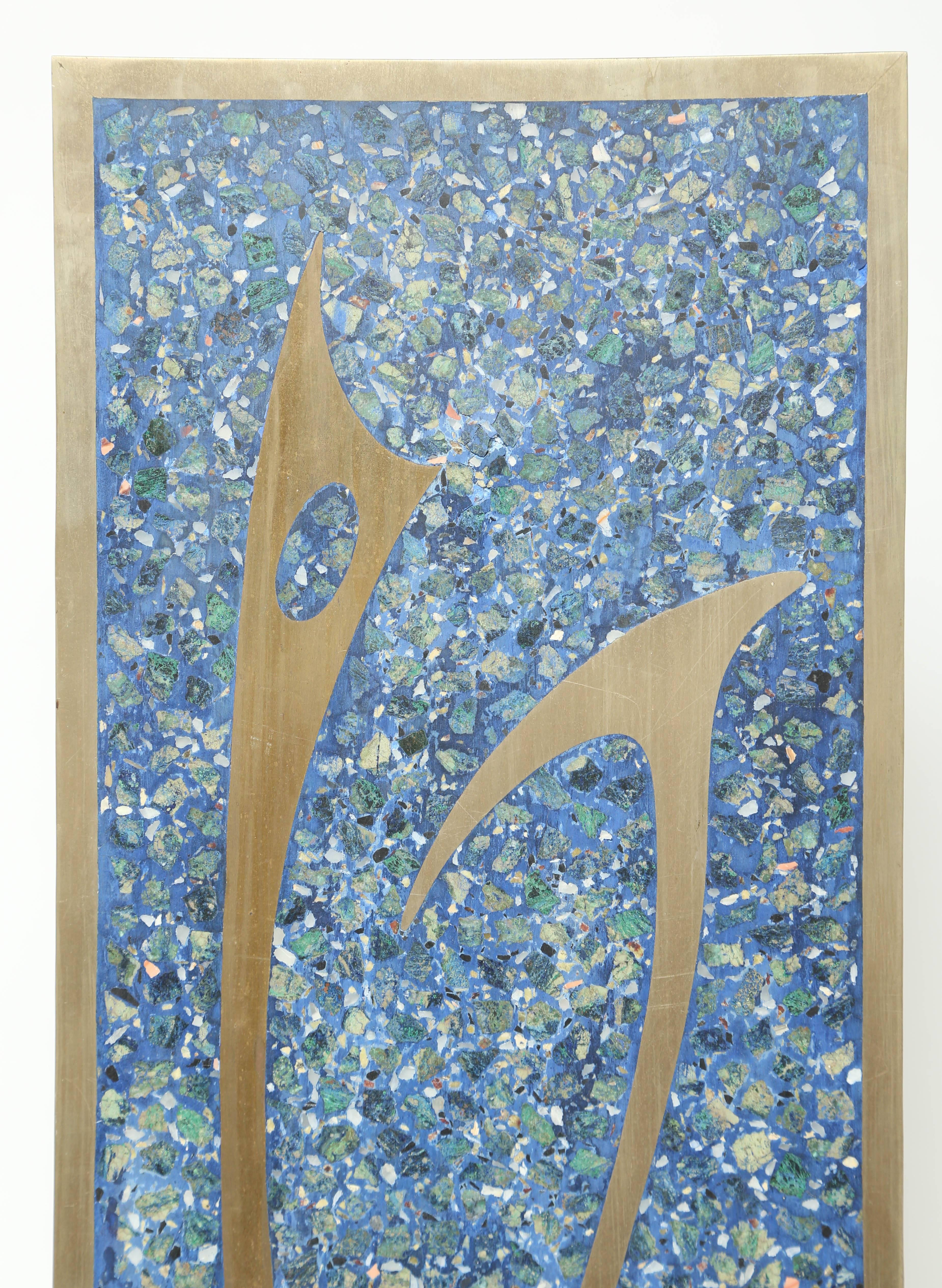 Large modern abstract wall sculpture designed and made by Sigi Pineda with a mosaic pattern background of natural stones including lapis lazuli and abstract cut-out of metal - bronze in two-tones and a bronzed framed border. Signature is done in