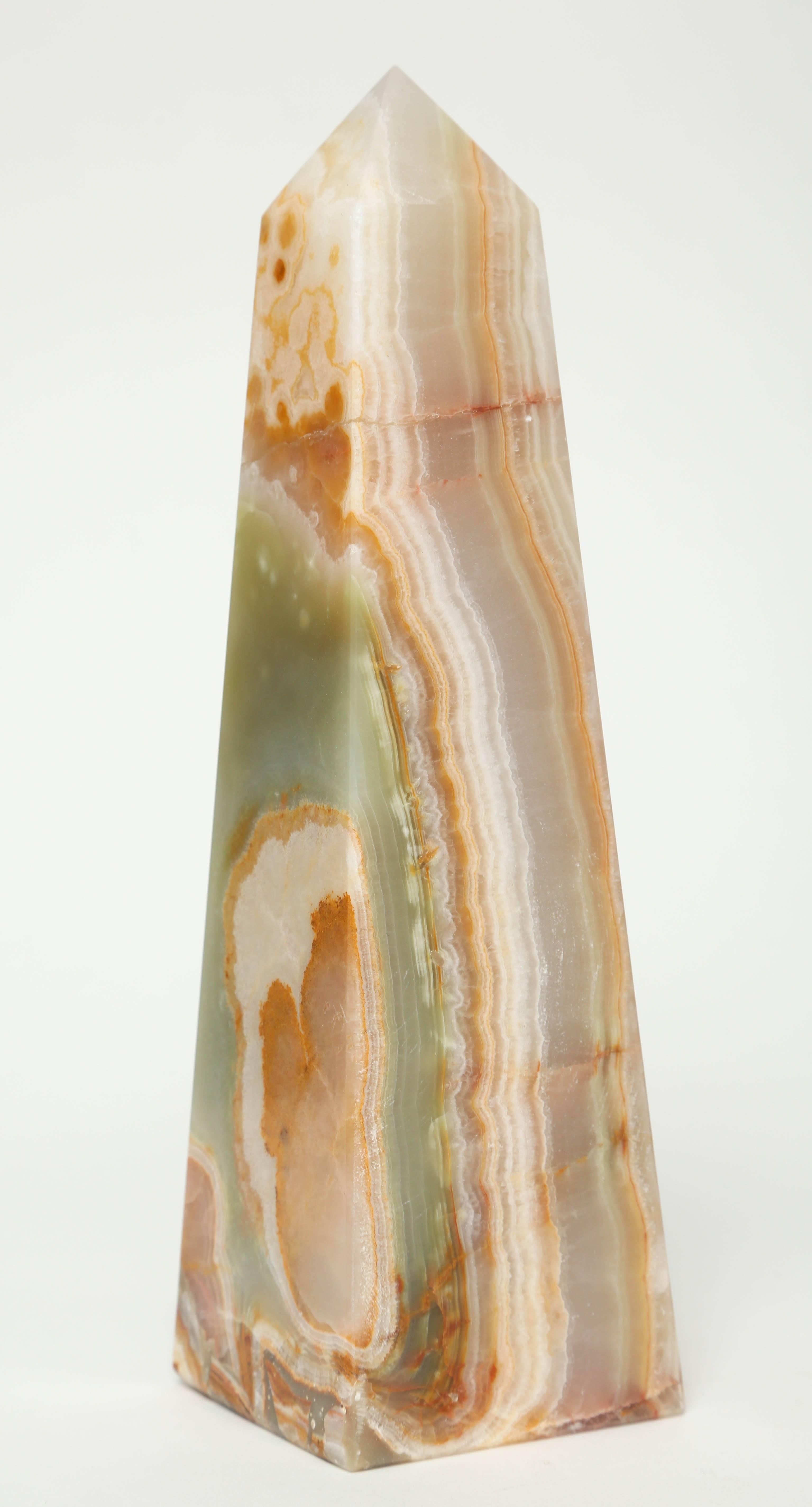 These stunning classically shaped onyx obelisk are probably continental in origin. They have beautiful veining with different hues of greens, ivory, rust and Browns. They are three different height and width which when grouped together make a